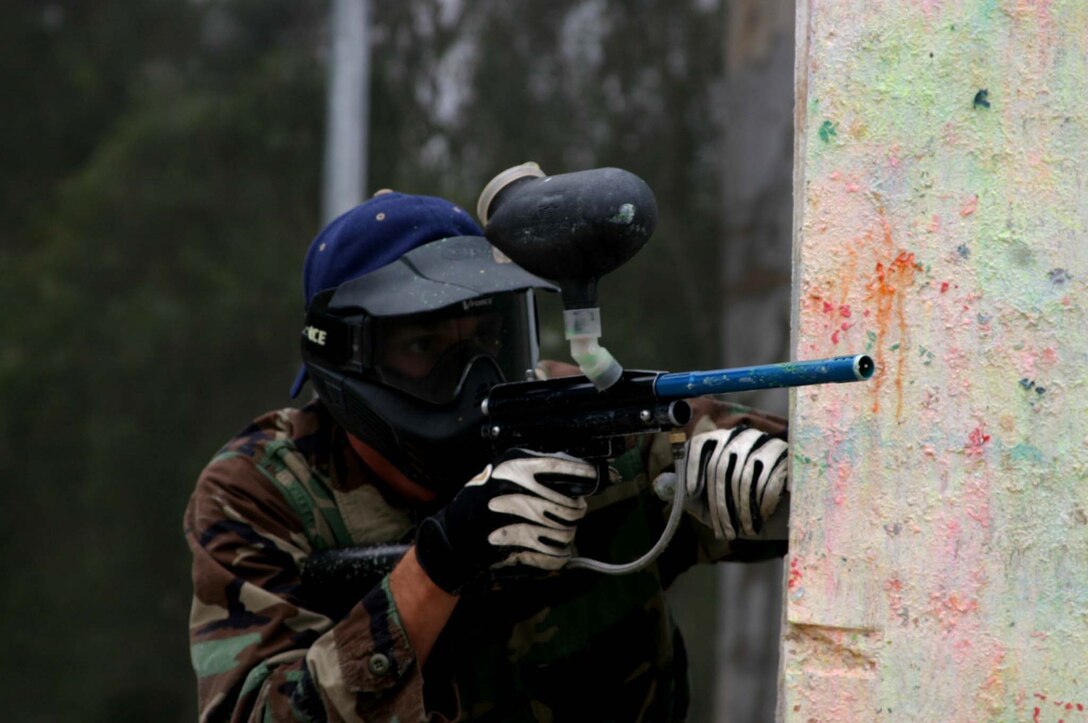 MARINE CORPS BASE CAMP PENDLETON, Calif. (Nov. 11, 2005) - Petty Officer 2nd Nathan E. Lloyd, an electronics technician with the Deep Submergence Unit, Naval Air Station, North Island, Coronado, peers around a corner and aims in with his paintball gun while battling his comrades at the Camp Pendleton Paintball Park. The 25-year-old from Brownsville, Pa., and 17 of his fellow sailors waged a friendly war of paintball against each other. Photo by: Cpl. Tom Sloan