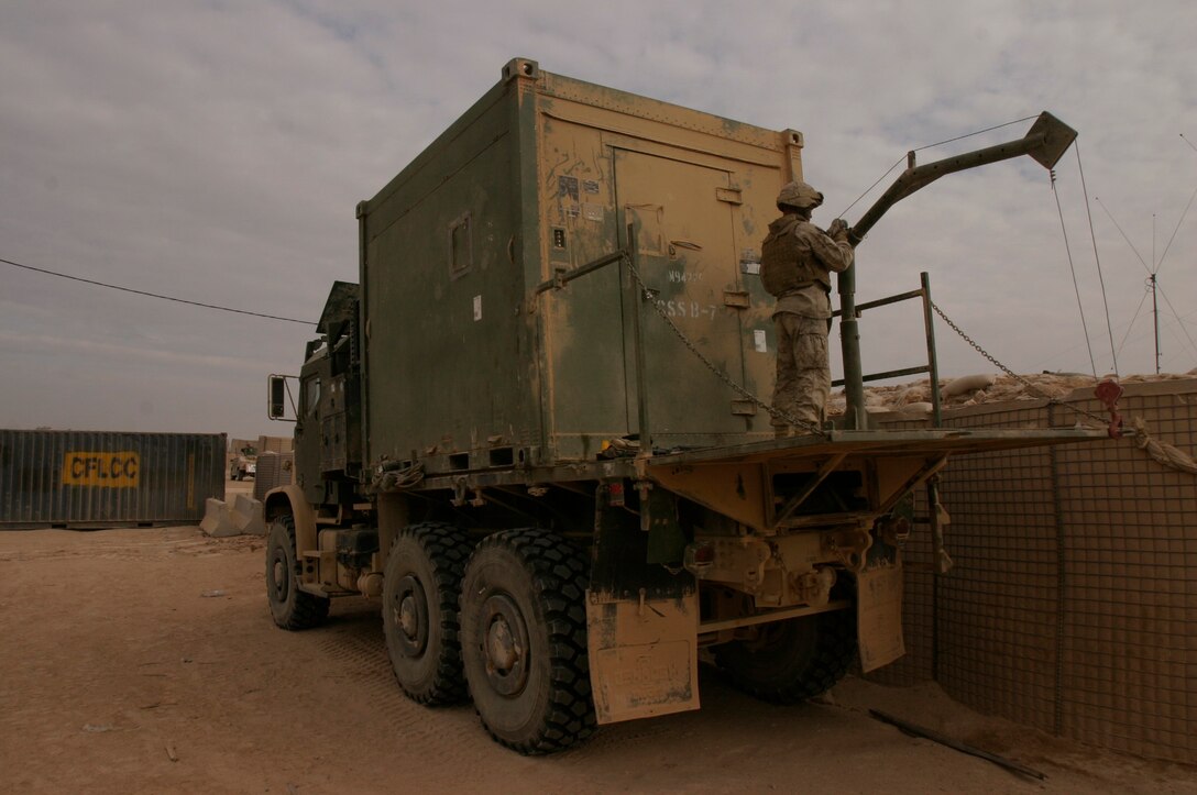 Sgt. Michael L. Dukes stands atop his unit’s modified MK-23 short-bed 7-ton truck used for the recovery and repair of disabled vehicles. Dukes is and amphibious assault vehicle mechanic and native of Bedford, Iowa, assigned to Combat Logistics Battalion-2, 2nd Marine Logistics Group (Forward).