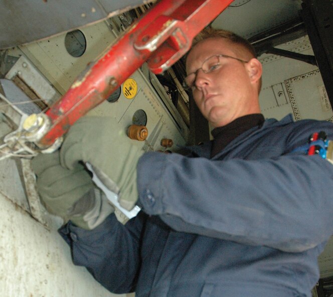 MINOT AIR FORCE BASE,  N.D. -- Staff Sgt. Ben Davis connects the support rods to a B-52H Stratofortress bomb bay doors.  The sergeant is a crew chief with the 5th Aircraft Maintenance Squadron. (U.S. Air Force photo by Senior Airman Danny Monahan)