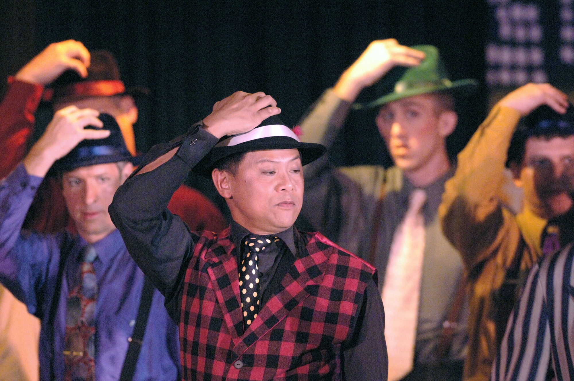 YOKOTA AIR BASE, Japan (AFPN) -- Bruce Gomez, center, performs in a "Guys and Dolls" production here. "Guys and Dolls" tells the story of a group of small-time gamblers and the women in their lives. The Yokota Players provide youths and adults education and experience in theatre and arts. (U.S. Air Force photo by Master Sgt. Val Gempis)