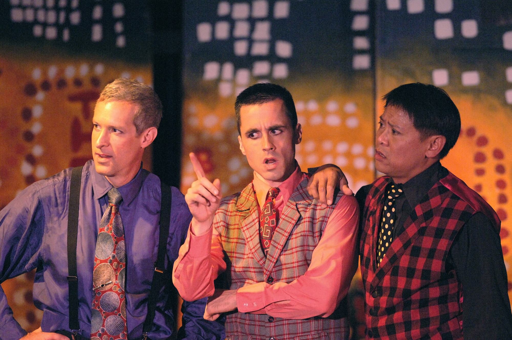 YOKOTA AIR BASE, Japan (AFPN) -- (Left-right) Bren Shuler, Nate Popp and Bruce Gomez, all members of the Yokota Players, perform in a "Guys and Dolls" production here. "Guys and Dolls" tells the story of a group of small-time gamblers and the women in their lives. The Yokota Players provide youths and adults education and experience in theatre and arts. (U.S. Air Force photo by Master Sgt. Val Gempis)