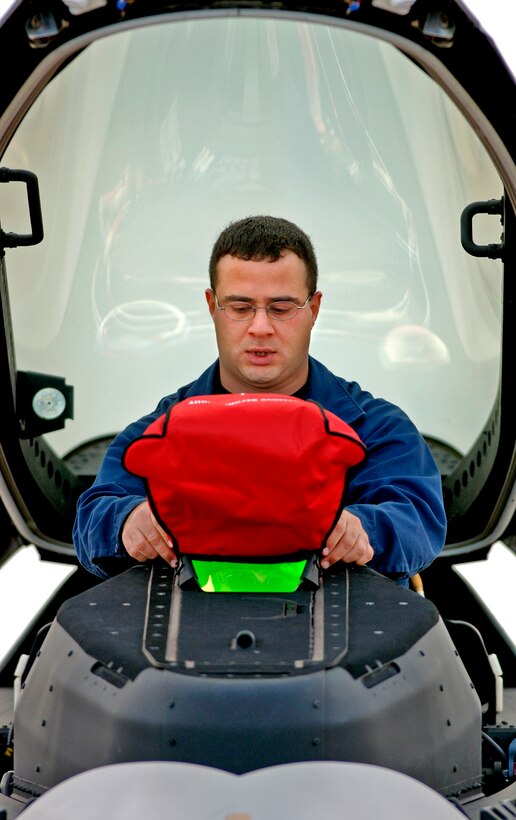 LANGLEY AIR FORCE BASE, Va. (AFPN) -- Airman 1st Class John Korkian does a post-flight inspection of an F/A-22 Raptor here after it returned from Hill Air Force Base, Utah.  The 27th Fighter Squadron just completed its first aircraft deployment giving pilots valuable "on the road" experience to include multiple opportunities to drop bombs at a local practice range.  Airman Korkian is a crew chief with the 27th Aircraft Maintenance Unit. (U.S. Air Force photo by Tech. Sgt. Ben Bloker)