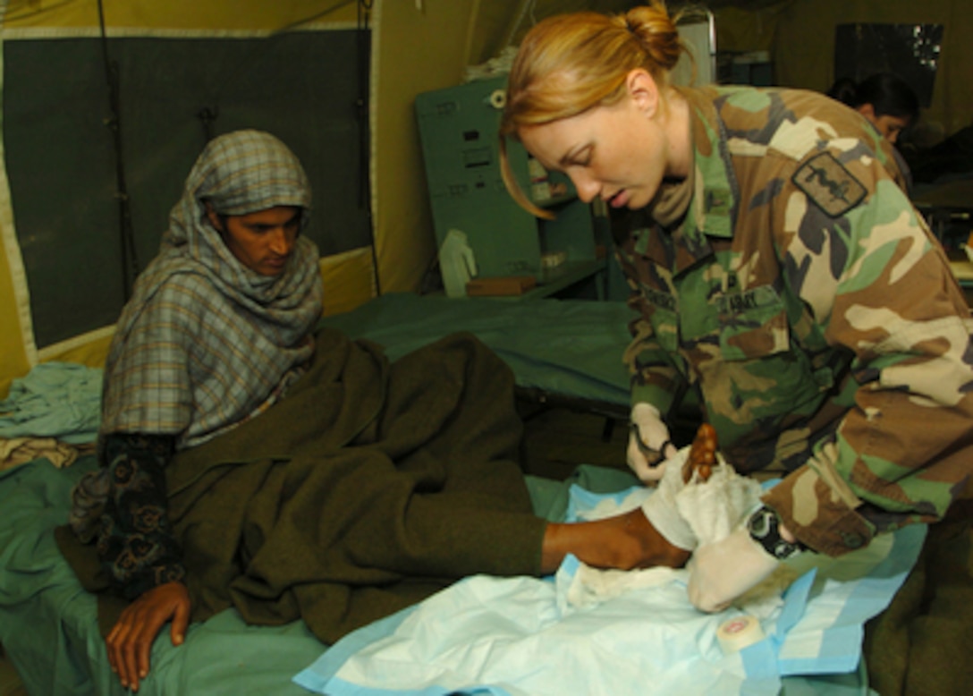 Army 2nd Lt. Miah Kwiatkowski removes gauze from a Pakistani woman's foot to check for swelling at the 212th Mobile Army Surgical Hospital in Muzaffarabad, Pakistan, on Nov. 1, 2005. The Pakistani woman is a victim of the devastating earthquake that struck the region Oct. 8, 2005. The Department of Defense is supporting the State Department by providing disaster relief supplies and services following the massive earthquake that struck Pakistan and parts of India and Afghanistan. 