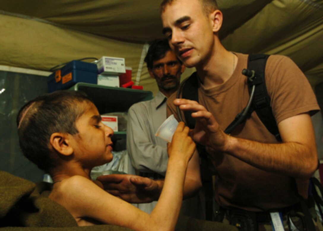 U.S. Army 1st Lt. Tory Marcon helps Riaz Sharif drink a powdered milkshake from a Meal, Ready to Eat, in Muzaffarabad, Pakistan, on Nov. 1, 2005. The milkshake is the only food tetanus patients at the 212th Mobile Army Surgical Hospital can manage to swallow because of muscle spasms. The Department of Defense is supporting the State Department by providing disaster relief supplies and services following the massive earthquake that struck Pakistan and parts of India and Afghanistan. 