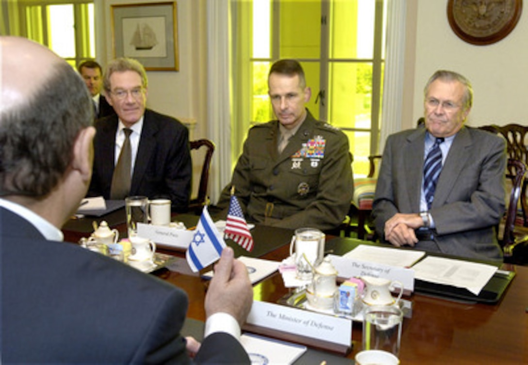 Secretary of Defense Donald H. Rumsfeld (right) hosts security talks with Israeli Minister of Defense Shaul Mofaz (foreground) in the Pentagon on Nov. 4, 2005. Assistant Secretary of Defense for International Security Affairs Peter Rodman (left) and Chairman of the Joint Chiefs of Staff Gen. Peter Pace (center), U.S. Marine Corps, joined Rumsfeld and Mofaz for the talks. 