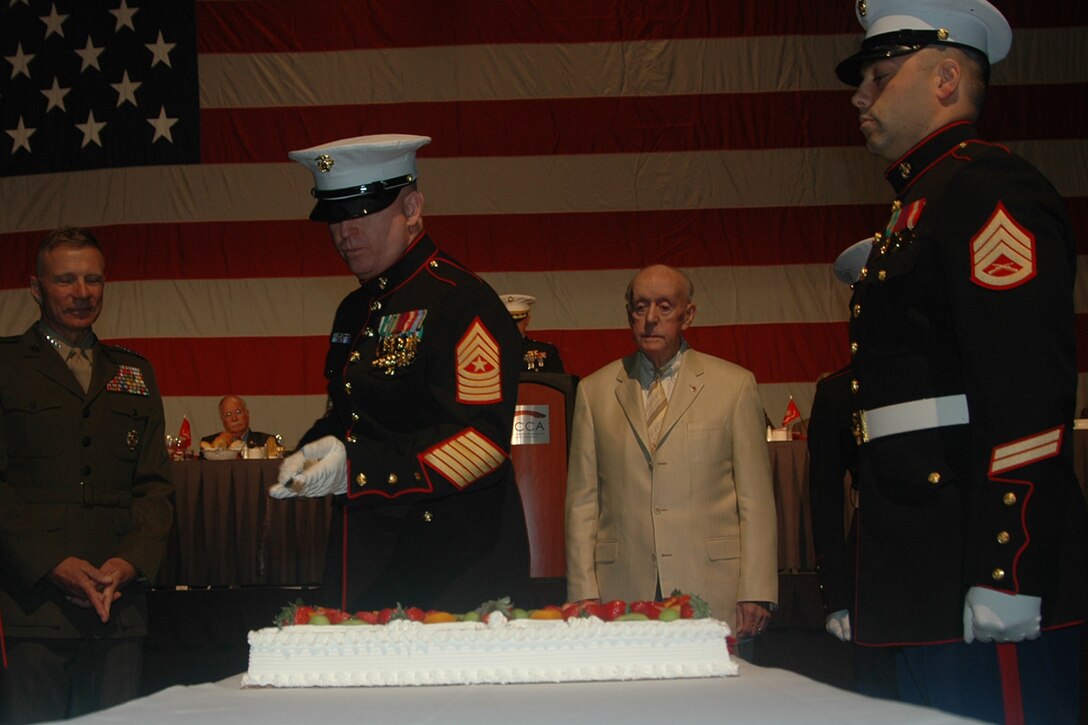 Sergeant Major Michael T. Allen, Marine Corps Recruiting Station Portsmouth, N.H. Sergeant Major, cuts a piece of Birthday Cake, while Commandant of the Marine Corps Gen. Michael W. Hagee looks on, during the Boston Semper Fidelis Society? annual Marine Corps Birthday Luncheon Nov. 8 at the Hynes Veterans Convention Center. Gen. Hagee was the guest speaker for the event.