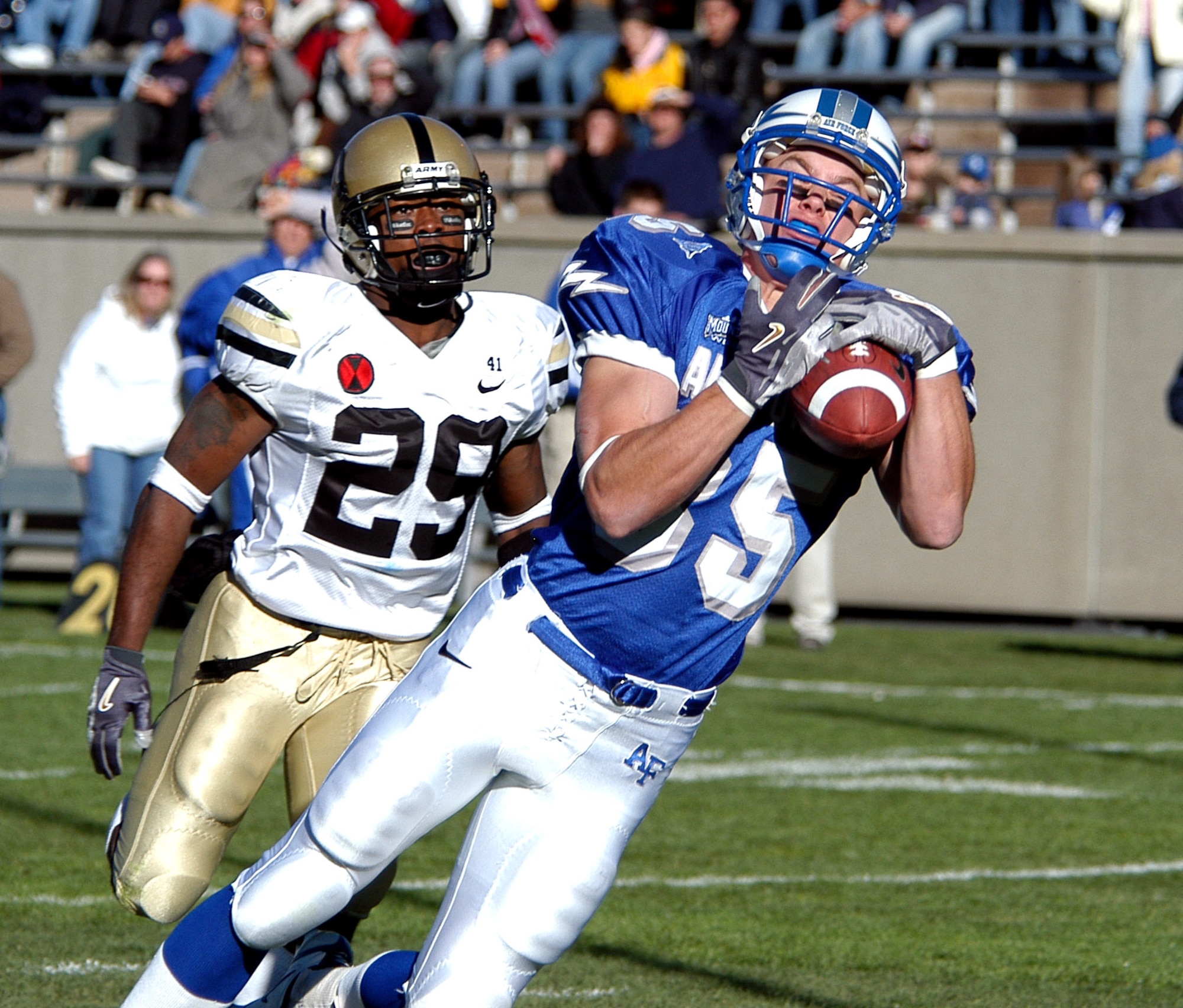 U.S. AIR FORCE ACADEMY, Colo. (AFPN) -- Falcon wide receiver Greg Kirkwood grabs a pass in front of Army defensive back Ray Smith. The pass was ruled incomplete after Kirkwood dove into the end zone. The Falcon wide out caught three balls in the game for 52 yards.  (U.S. Air Force photo by John Van Winkle)