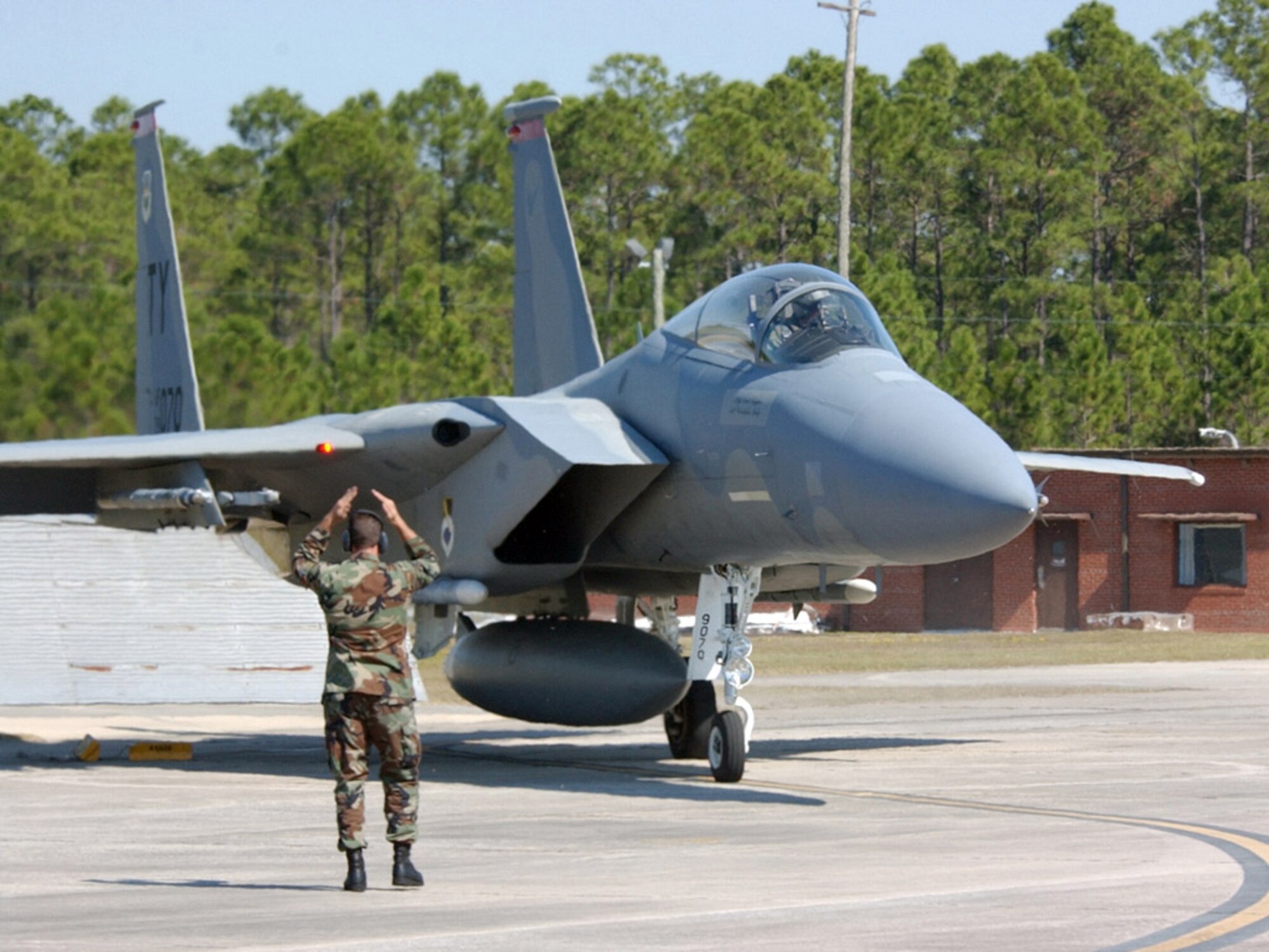 TYNDALL AIR FORCE BASE, Fla. (AFPN) -- A crew chief marshals out Capt. Eric Haas during a War Day alert scramble.  After the alert horn sounded, Captain Haas ran to his F-15 Eagle and was ready for takeoff in 3 minutes, 15 seconds. (U.S. Air Force photo by 2nd Lt. William Powell) 