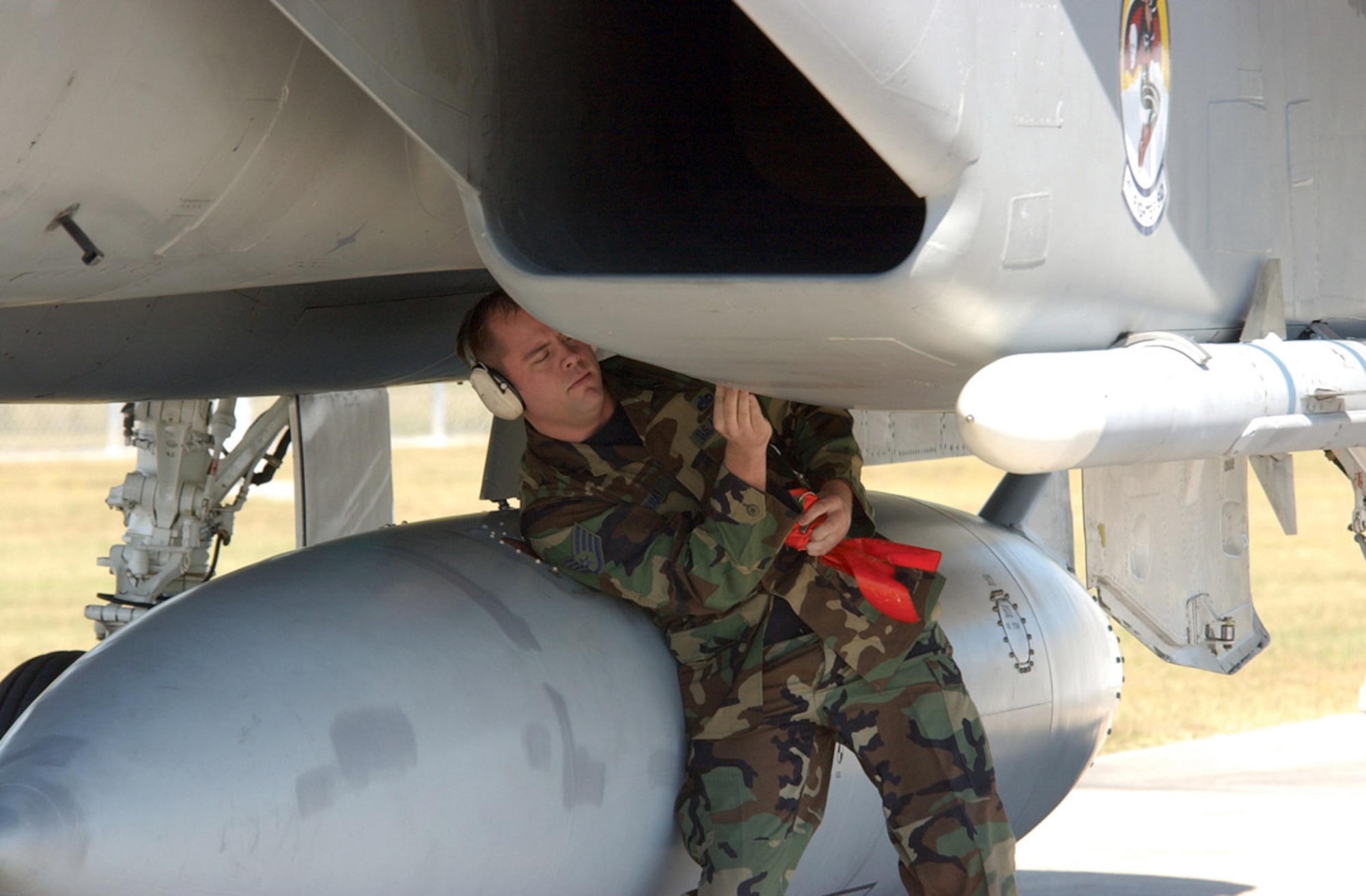TYNDALL AIR FORCE BASE, Fla. -- Staff Sgt. Rich Murray pulls the safety pins from an F-15 Eagle during an alert scramble.  Sergeant Murray is with the 1st Aircraft Maintenance Squadron here. (U.S. Air Force photo by 2nd Lt. William Powell)