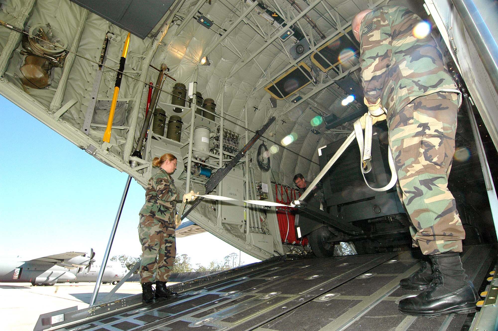 KEESLER AIR FORCE BASE, Miss. (AFPN) -- Reservists from the 41st Aerial Port unload a 5,000 pound generator from a C-130J Hercules.  The aircraft returned home after flying missions out of Dobbins Air Reserve Base, Ga., since Hurricane Katrina bashed apart its home base.  The 403rd Wing mission, which includes the 53rd Weather Reconnaissance Squadron's "Hurricane Hunters" and the 815th Airlift Squadron's "Flying Jennies," fully reinstated its mission at Keesler after Hurricane Katrina damaged their home unit. (U.S. Air Force photo by Tech. Sgt. Chance Babin)
