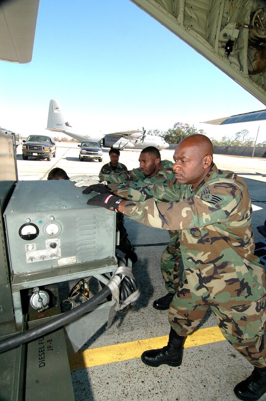 KEESLER AIR FORCE BASE, Miss. (AFPN) -- Reservists from the 41st Aerial Port unload a 5,000 pound generator from a C-130J Hercules.  The aircraft returned home after flying missions out of Dobbins Air Reserve Base, Ga., since Hurricane Katrina bashed apart its home base.  The 403rd Wing mission, which includes the 53rd Weather Reconnaissance Squadron's "Hurricane Hunters" and the 815th Airlift Squadron's "Flying Jennies," fully reinstated its mission at Keesler after Hurricane Katrina damaged their home unit. (U.S. Air Force photo by Tech. Sgt. Chance Babin)