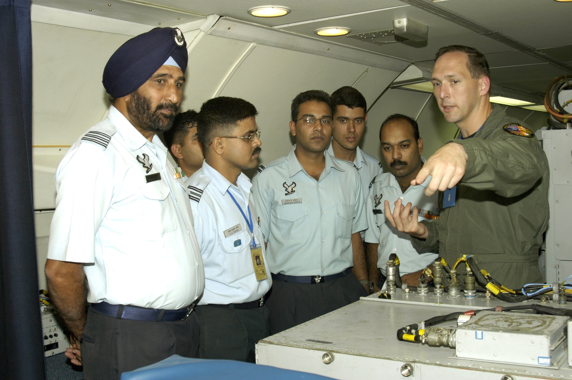 KALAIKUNDA AIR STATION, India (AFPN) -- Capt. James Munroe explains E-3 Sentry airborne warning and control system aircraft capabilities to Indian Air Force radar officers during exercise Cope India '06 here. Captain Munroe is from the 961st Airborne Air Control Squadron, Kadena Air Base, Japan.  The exercise began Nov. 7.  (U.S. Air Force photo by Tech. Sgt. Martin Jackson) 