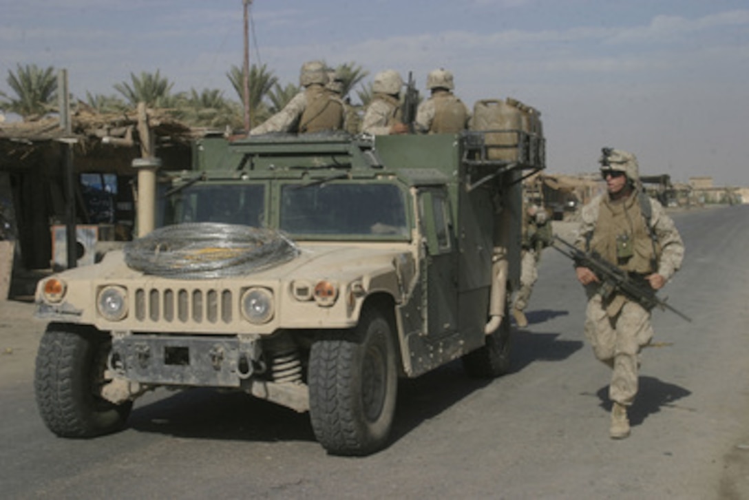 U.S. Marines from 3rd Platoon, Company E, 2nd Battalion, 2nd Marine Division enter the Al Sadan market in Zaidon, Iraq, to search for arms and high-value targets on Nov. 6, 2005. The 2nd Marine Division is conducting counter-insurgency operations in the area. 