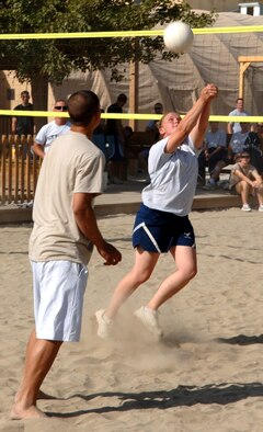 BAGRAM AIR BASE, Afghanistan (AFPN) -- Sarah Beauchamp sets the ball during a volleyball tournament. The tournament is one of many events put together by professional organizations here. Airman Beauchamp is deployed from Dover Air Force Base, Del., and is assigned to the 455th Expeditionary Security Forces Squadron. (U.S. Air Force photo by Staff Sgt. Marcus McDonald)