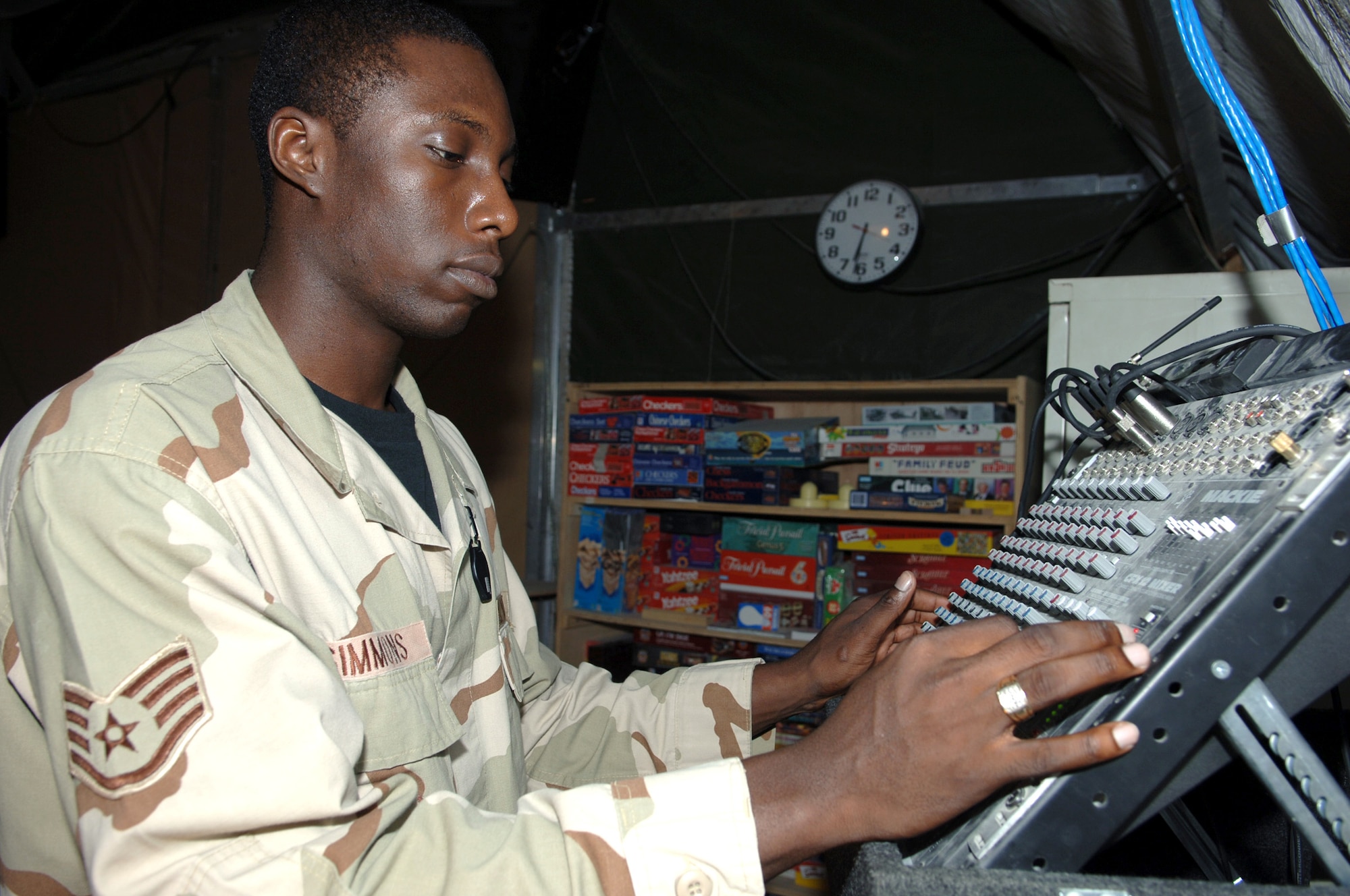 BAGRAM AIR BASE, Afghanistan (AFPN) -- Staff Sgt. Charles Simmons checks the sound level before hip hop night. Hip hop night is one of many morale-building programs here. All three organizations -- Airmen Committed to Excellence, Middle Tier Association, and the Top 3 Organization -- are doing their part supporting the 455th Expeditionary Services Squadron's morale-building initiatives. Sergeant Simmons is from Nashville, Tenn., and deployed from Davis-Monthan Air Force Base, Ariz. (U.S. Air Force photo by Staff Sgt. Marcus McDonald)