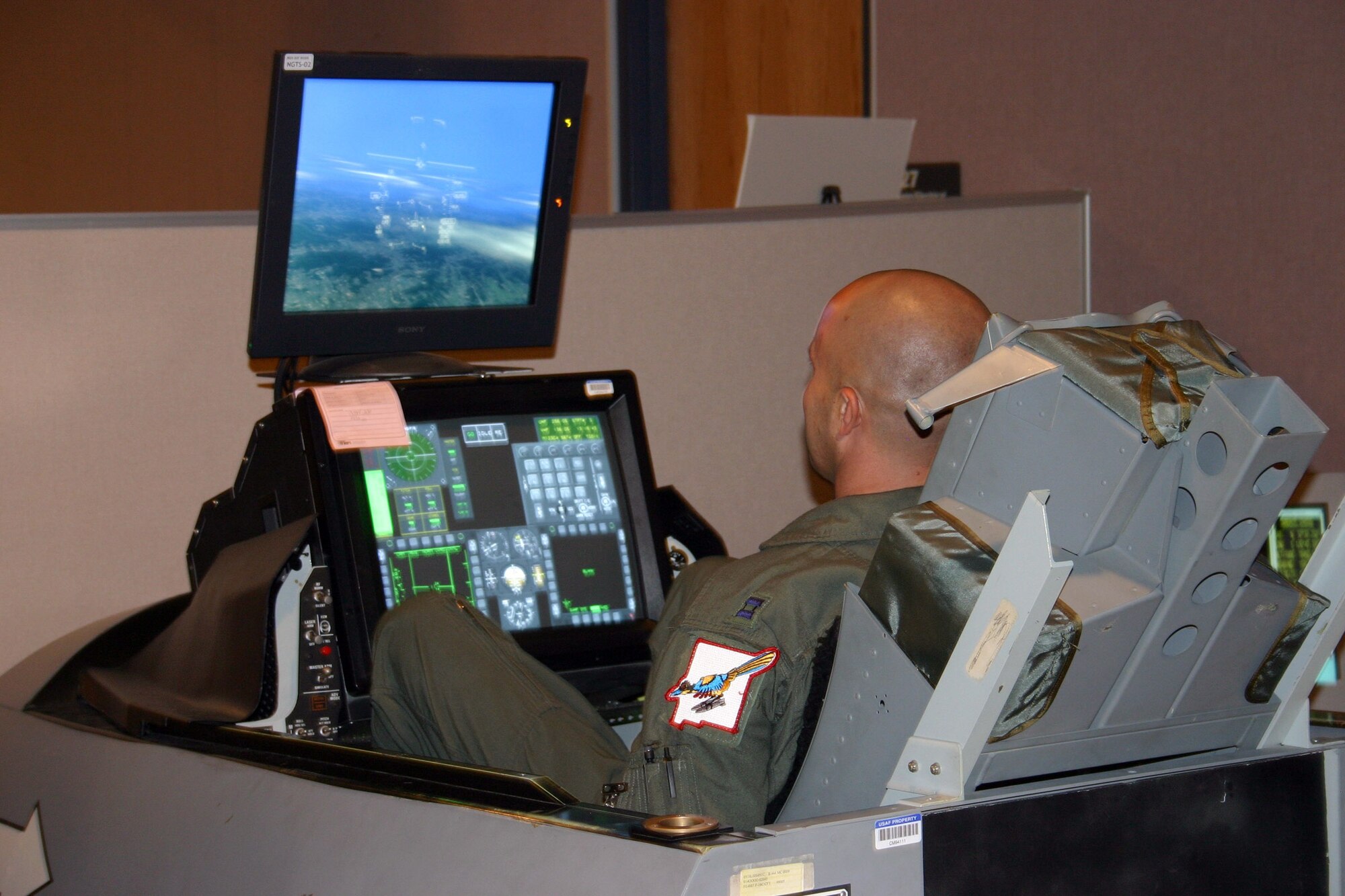KIRTLAND AIR FORCE BASE, N.M. (AFPN) - Capt. Ryan McGuire flies a MIG-29 mission on a simulator at the Distributed Mission Operations Center here during Virtual Flag 06. The "enemy" mission, Nov. 3, was the first time an adversary pilot was integrated into the simulation to actively engage U.S. forces. Captain McGuire's aircraft was displayed on the screens of simulators around the country as Air Force aircrews flew missions and participated in the exercise from their home bases. Captain McGuire is an F-16 pilot with the 150th Fighter Wing. (U.S. Air Force photo by 1st Lt. Nathan D. Broshear)