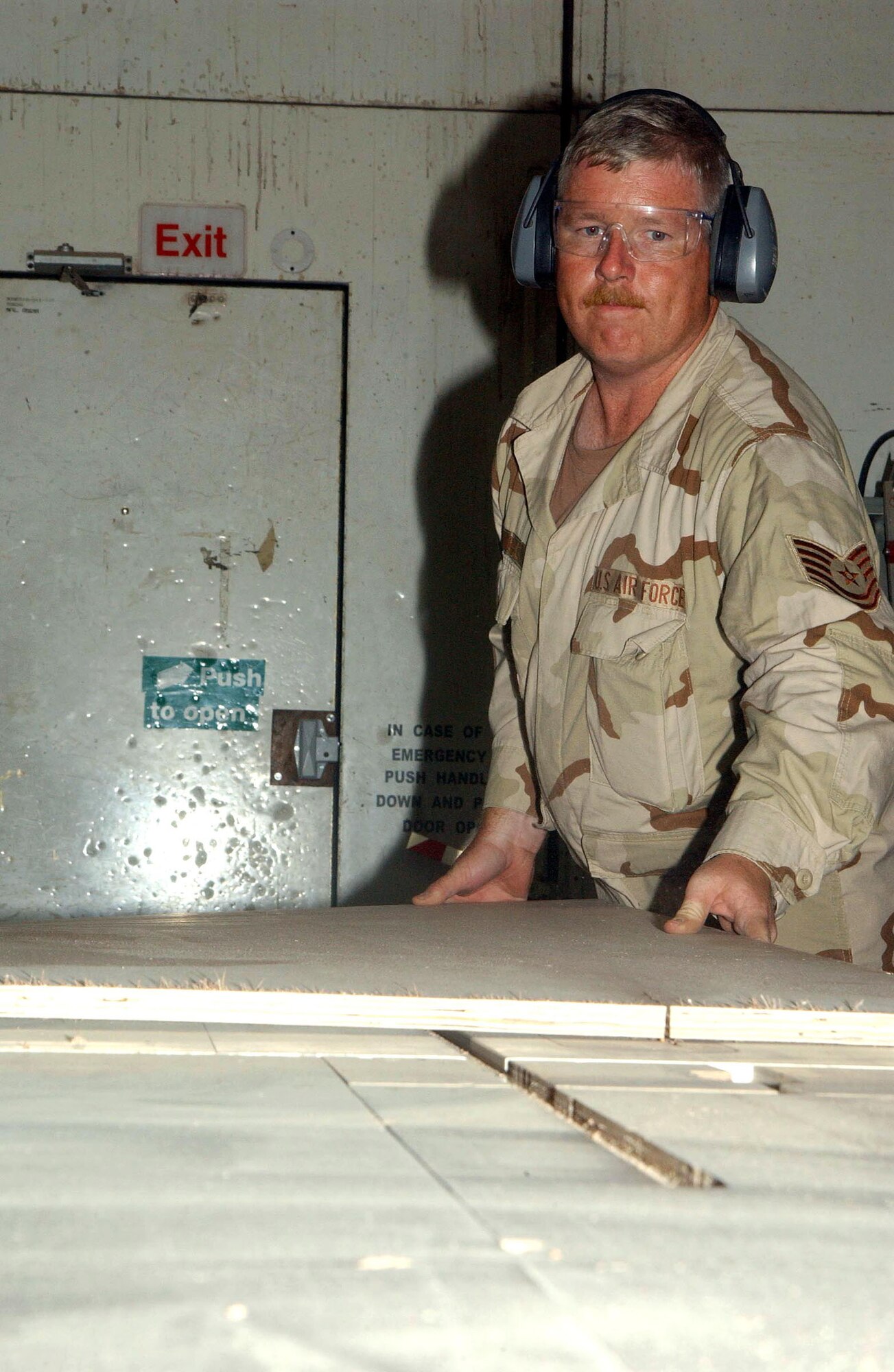 SOUTHWEST ASIA (AFPN) -- Tech. Sgt. Jonathan D. Gambill uses a table saw to cut a new door for one of the residential lodging tents here.  Sergeant Gambill is one of several structural maintenance technicians assigned to take care of a variety of buildings, tents and hangars here.  He is deployed to the 380th Expeditionary Civil Engineer Squadron from Luke Air Force Base, Ariz.  (U.S. Air Force photo by Tech. Sgt. Mike Hammond)
