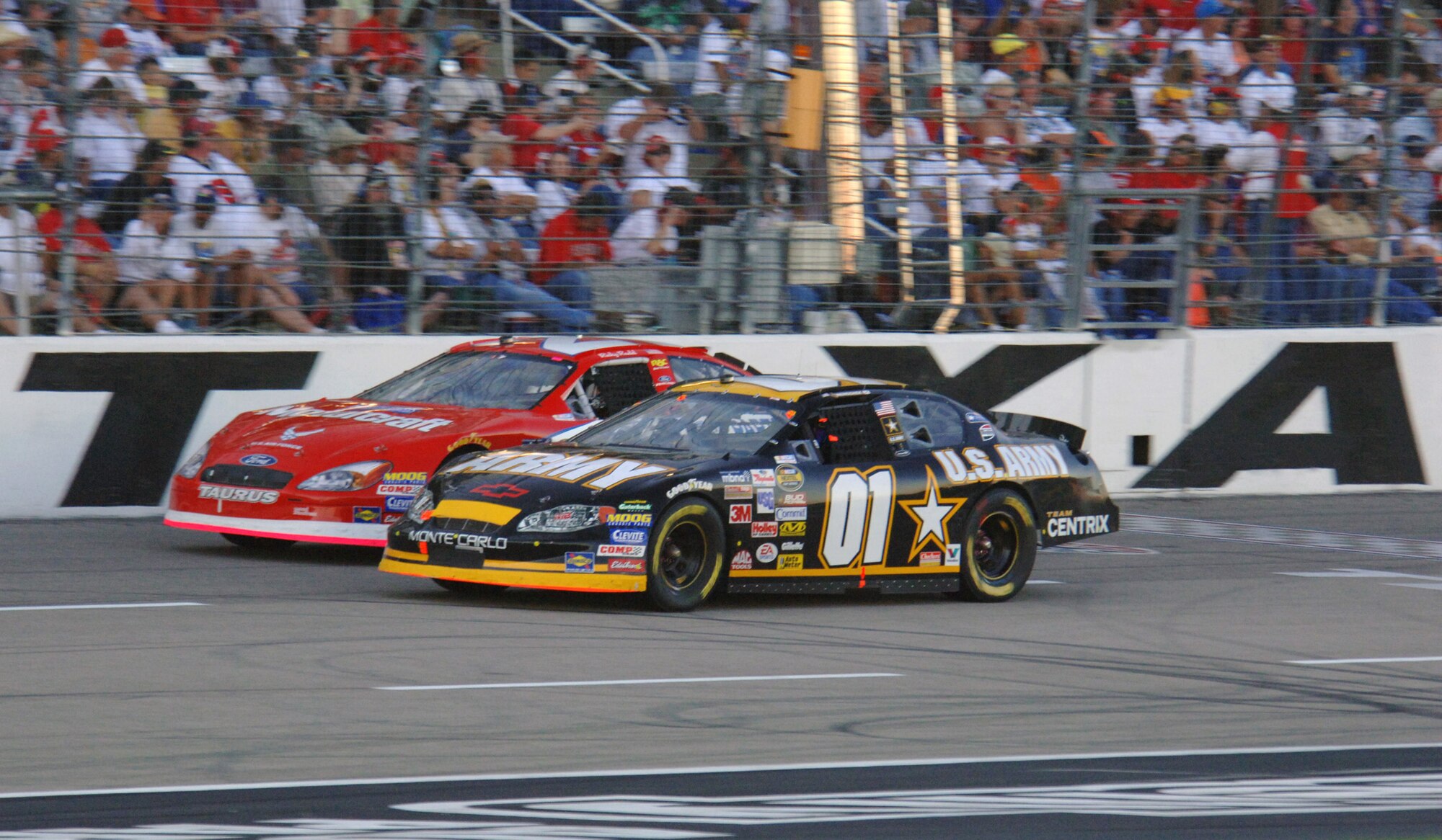 TEXAS MOTOR SPEEDWAY, Texas (AFPN) -- The NASCAR Nextel Cup Series Air Force co-sponsored car, number 21, battles for position with Joe Nemecheck driving the Army car, number 01, during the inaugural running of the Dickies 500.  Ricky Rudd finished in 13th place, with Joe Nemecheck finishing in 37th place. This is the fifth straight year of the Air Force sponsorship of NASCAR. (U.S. Air Force photo by Master Sgt Michael A. Kaplan)