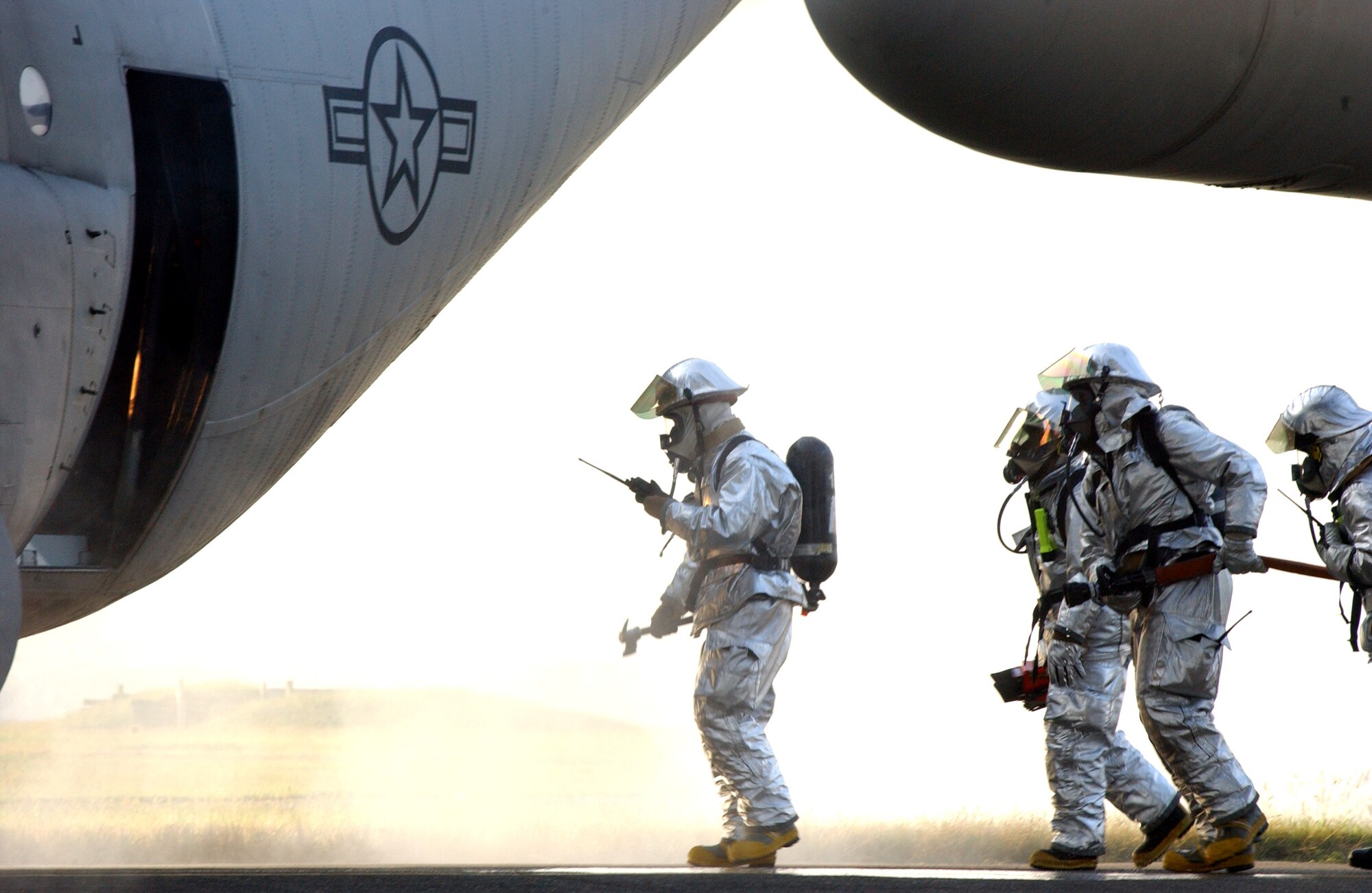 YOKOTA AIR BASE, Japan (AFPN) -- Firefighters simulate battling a fire after a simulated plane crash during a full spectrum threat response exercise here.  The exercise sharpens Airmen's abilities to respond to aircraft accidents. The firefighters are with the 374th Civil Engineering Squadron. (U.S. Air Force photo by Airman 1st Class Ladonnis Crump) 