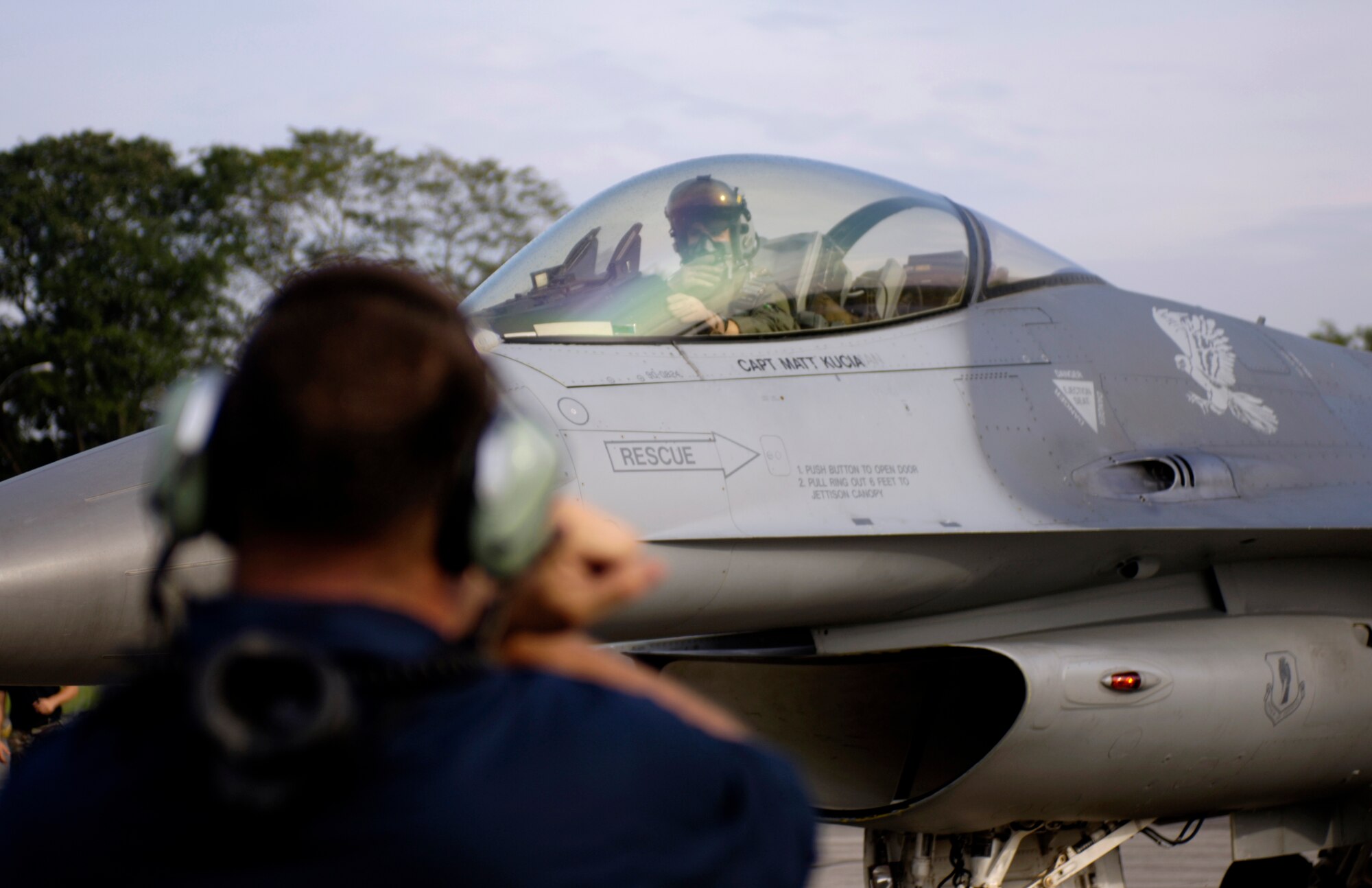 PAYA LEBAR AIR BASE, Singapore -- Staff Sgt. Keith White prepares to launch his F-16 Fighting Falcon for a mission Paya Lebar Air Base, Singapore, during Exercise Commando Sling. The annual exercise began in 1990 to provide combined air combat training for U.S. Air Force and Singapore Air Force fighter units. The exercise enables units to sharpen air combat skills, improve procedures for sustained operations at a non-U.S. base, and promote closer relations between the two air forces and nations. Sergeant White is a crew chief from the 14th Fighter Squadron, 35th Fighter Wing, Misawa, Japan. (U.S. Air Force photo by Tech. Sgt. Shane A. Cuomo)

