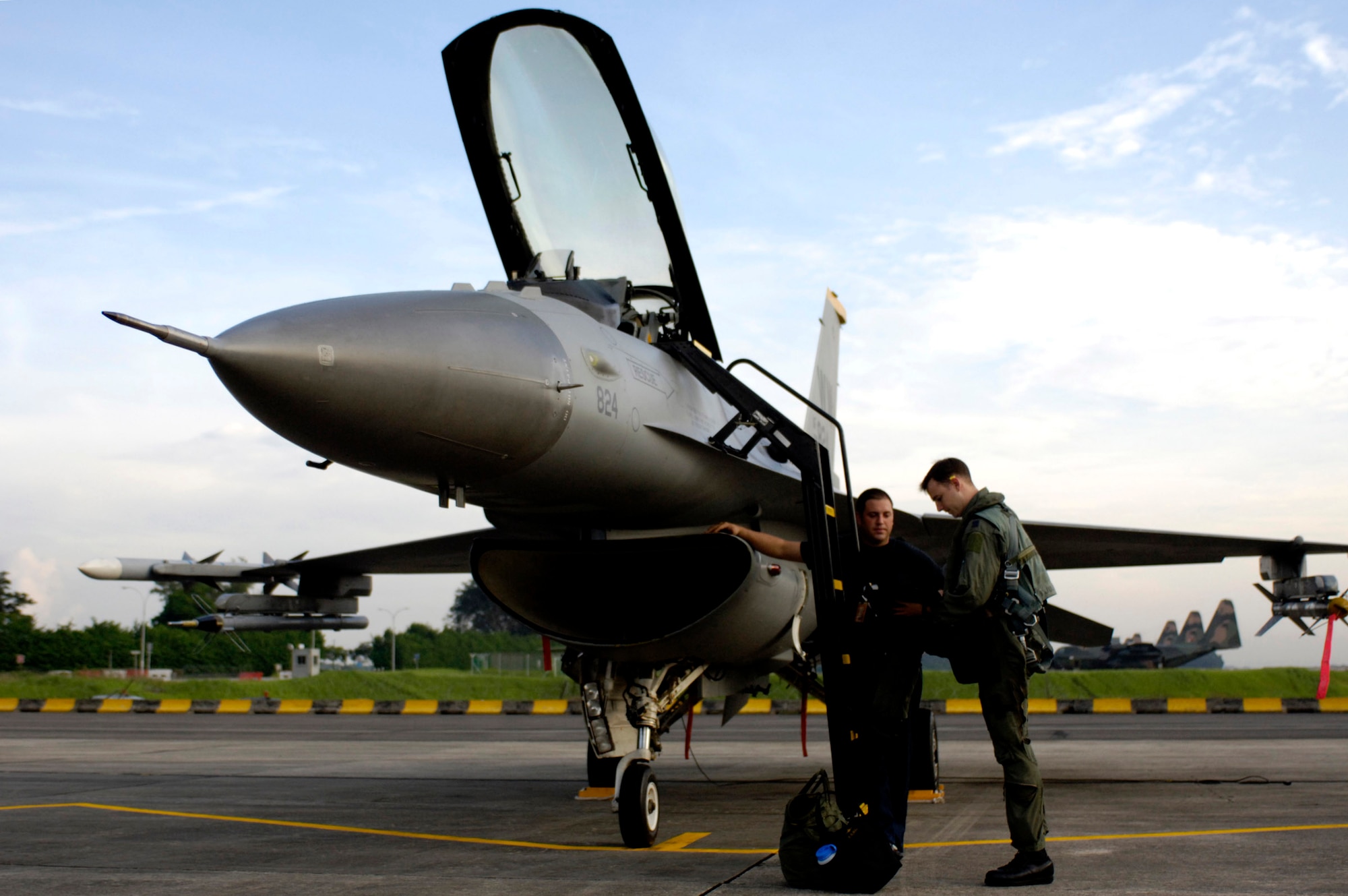 PAYA LEBAR AIR BASE, Singapore -- Capt. Michael May and Staff Sgt. Keith White look over the maintenance log before a mission here during Exercise Commando Sling.  The Airmen are from the 14th Fighter Squadron at Misawa Air Base, Japan.  (U.S. Air Force photo by Tech. Sgt. Shane A. Cuomo)