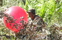 Staff Sgt. Jody Ball, 10th Combat Weather Squadron, inflates a weather balloon during an exercise held near Hurlburt Field, Fla. The balloon is used to determine wind direction and velocity.