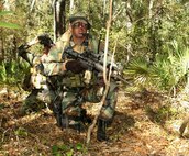 Staff Sgt. Jody Ball, 10th Combat Weather Squadron, provides security for Tech Sgt. Rick Rohde, 10th CWS, as he collects cloud cover information during an exercise held near Hurlburt Field, Fla. 