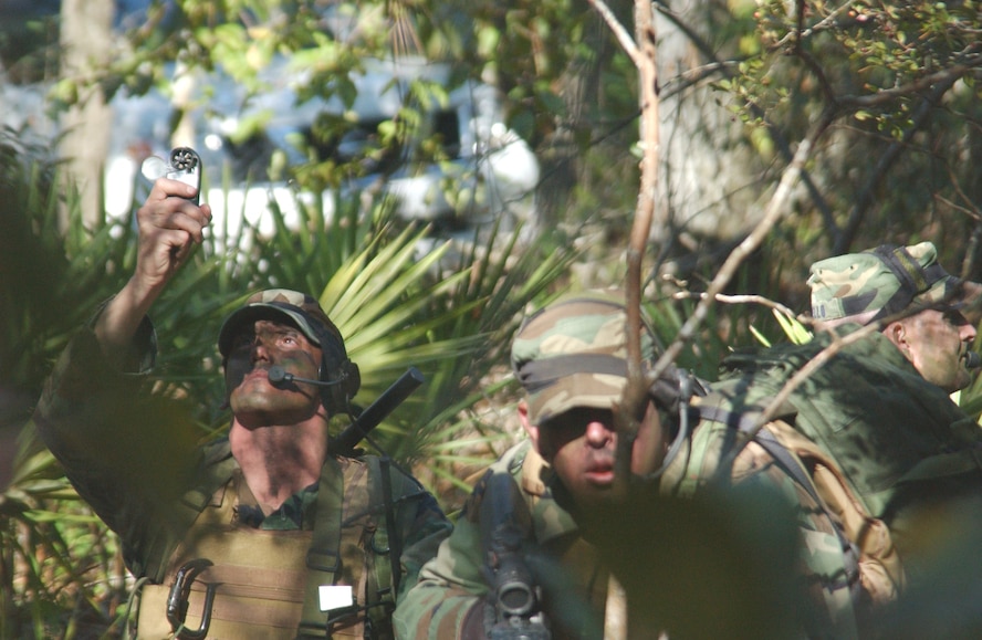 Staff Sgt. Jody Ball, front, 10th Combat Weather Squadron, and Tech Sgt. Jim Morello, right, provide security as Tech Sgt. Rick Rohde collects weather data during an exercise held near Hurlburt Field, Fla.