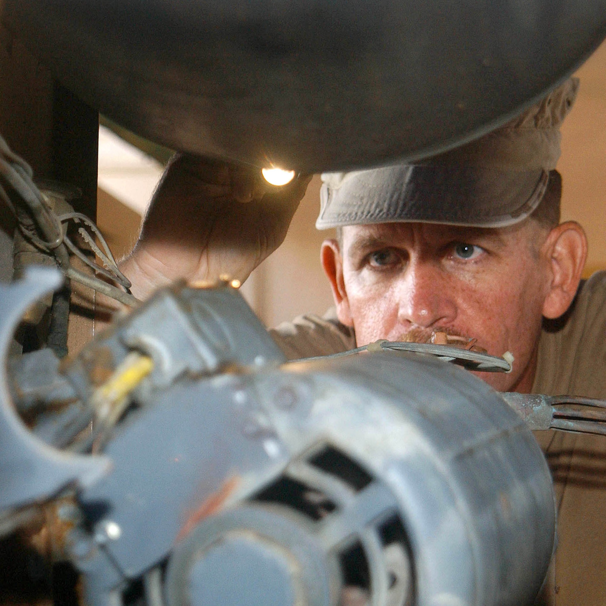 SOUTHWEST ASIA -- Tech. Sgt. Mark Flanders inspects a wiring location prior to removing the evaporator motor in an environmental control unit here.  Sergeant Flanders is an Air Force Reservist deployed to the 380th Expeditionary Civil Engineer Squadron from Selfridge Air National Guard Base, Mich.  (U.S. Air Force photo by Tech. Sgt. Mike Hammond)
