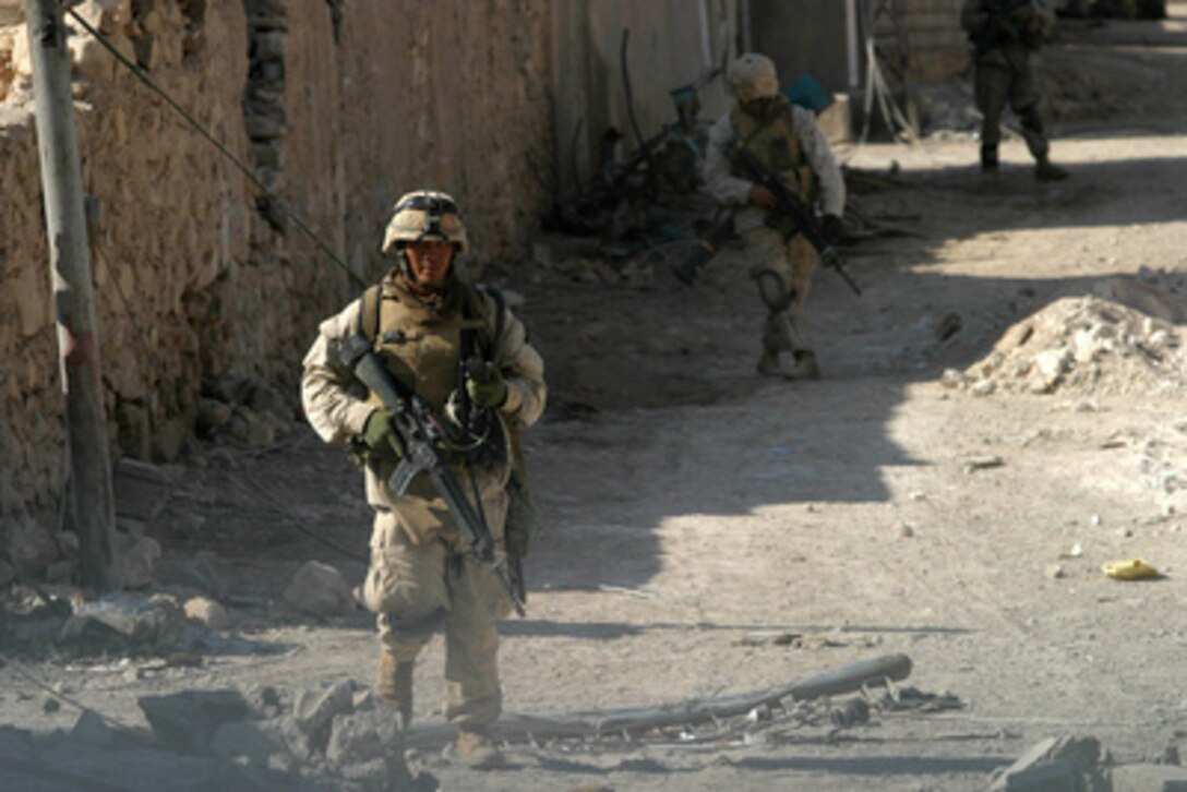 U.S. Marines with 1st Platoon, Echo Company, 2nd Battalion, 1st Marine Regiment, conduct a security patrol through the streets of Husaybah, Iraq, during Operation Steel Curtain on Nov. 8, 2005. 