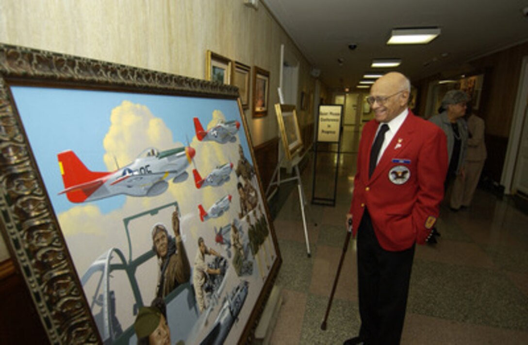 Tuskegee Airman retired Col. Elmer Jones smiles as he looks at an oil painting depicting some of the history of the Tuskegee Airmen on display in the Pentagon on Nov. 10, 2005. The Airmen are at the Pentagon to receive briefings on the state of the Air Force, an update on global operations and have lunch with Secretary of Defense Donald H. Rumsfeld. During World War II, the Tuskegee Airmen were credited with destroying 261 aircraft, damaging 148 aircraft, flying 15,553 combat sorties and 1,578 missions over Italy and North Africa. They destroyed or damaged over 950 units of ground transportation and escorted more than 200 bombing missions. As an escort fighter wing during World War II, they never lost a bomber to enemy fighters. 
