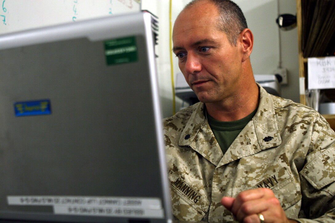 AL TAQADDUM, Iraq (Sept. 13, 2007) ? Cmdr. John Manning works on his computer at the Taqaddum Surgical Facility. Manning was one of many sailors who recently began a seven-month deployment by taking control of the facility. Manning is a Boston native and a nurse practitioner with his detachment.