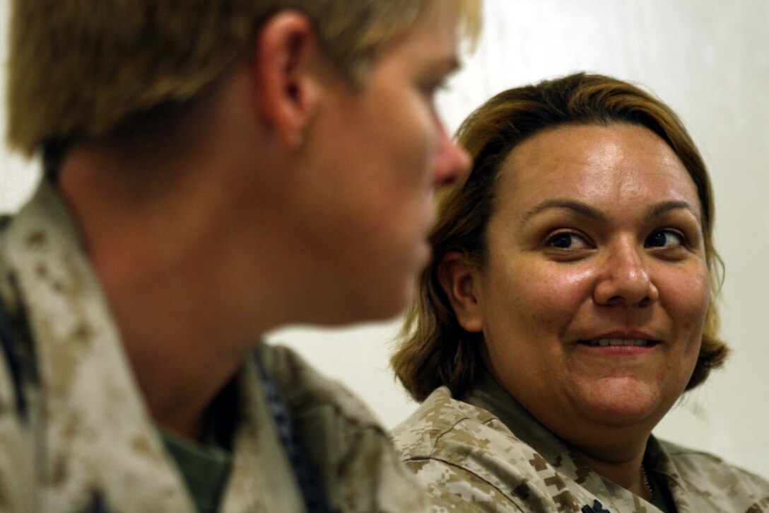 AL TAQADDUM, Iraq (Sept. 13, 2007) ? Petty Officer  1st Class Veronyka T. Young speaks with one of her colleagues. Young and the rest of the medical staff currently serving here took full control of the surgical facility, Sept. 8. Young is an Independent Duty Corpsman and a San Diego native.