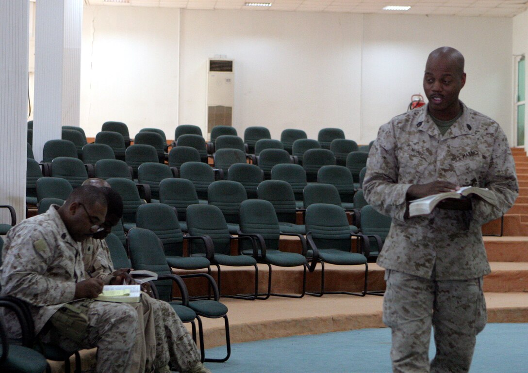 Gunnery Sgt. Terrance R. Moore, postal chief, Postal Detachment 6, Service Company, Headquarters and Service Battalion, 2nd Marine Logistics Group (FWD), gives an inspirational message during the gospel service here Nov. 3, 2005. Moore has been instrumental in the religious programs throughout his multiple deployments.