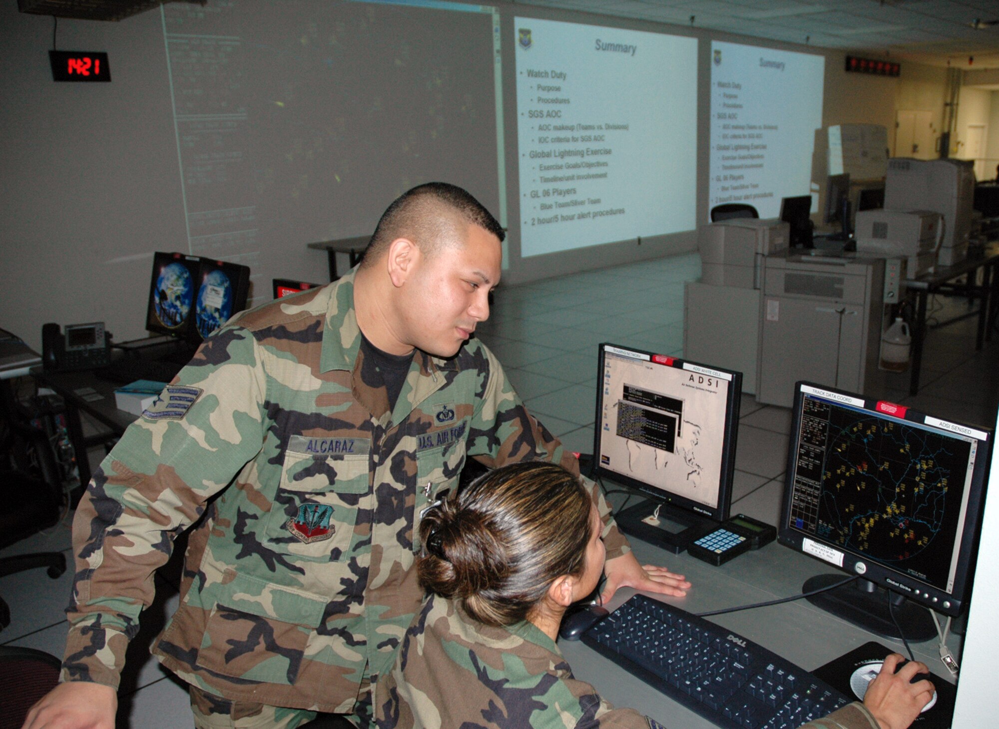 BARKSDALE AIR FORCE BASE, La. (AFPN) -- Staff Sgts. Oliver Alcaraz and Ruby Perez review datalink information in the combined air and space operations center. Both sergeants are with the 608th Combat Operations Squadron. (U.S. Air Force photo by 2nd Lt. Frank Hartnett) 