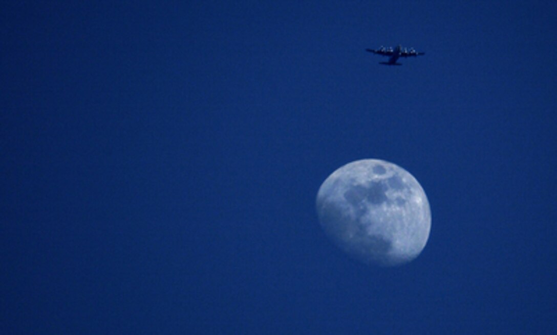 A U.S. Air Force C-130 Hercules approaches the Golf drop zone for a parachute drop near Camp Lemonier, Djibouti, on Nov. 12, 2005. Navy Explosive Ordnance Technicians and Air Force personnel from the 131st Emergency Rescue Squadron are completing the parachute jumps to maintain qualifications. 