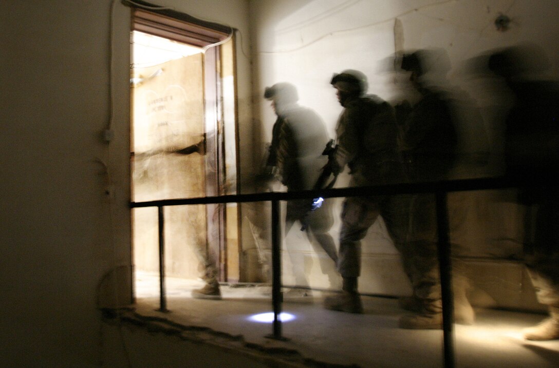 U.S. Marines with Lima Battery, 3rd Battalion, 10th Marines clear rooms inside the Joint Direct Attack Munitions palace during a training exercise on Camp Blue Diamond, Iraq, Nov. 15, 2005.  The 2nd Marine Division conducts counterinsurgency operations to facilitate the creation of a secure environment that enables Iraqi self-reliance and self-governance. DoD photo by Cpl. James P. Douglas, U.S. Marine Corps. (Released)