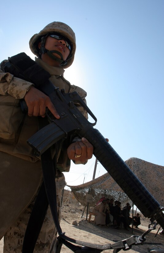 Lance Cpl. Joyce N. Fundweburk stands guard here Nov. 16. Female Marines from various units within Combat Logistics Brigade-8, 2nd Marine Logistics Group, stand at the gates of Fallujah to ensure the city remains safe by checking female Iraqis for dangerous materials. Fundweburk is a supply warehouseman with CLB-8, 2nd MLG.