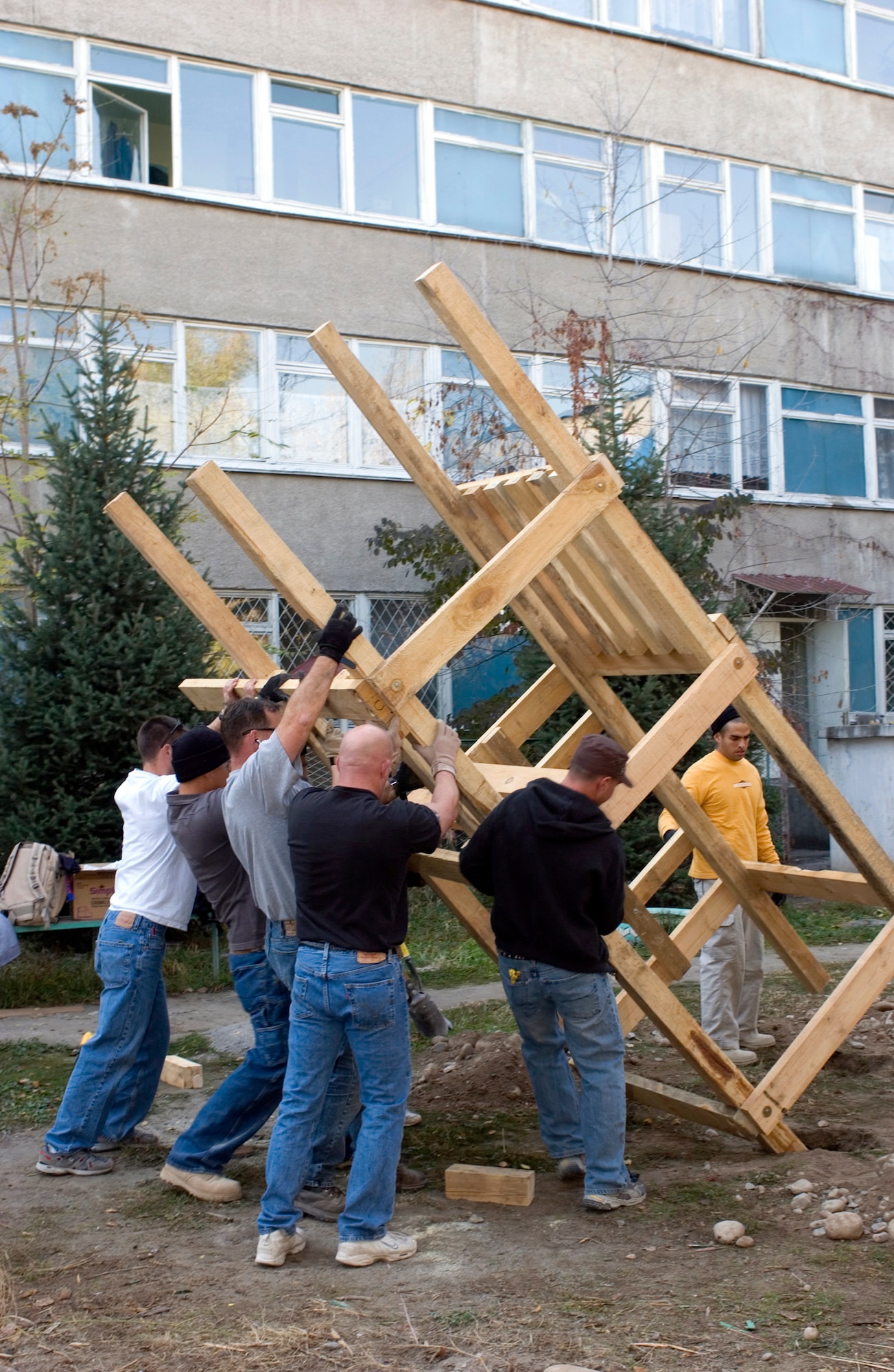 BISHKEK, Kyrgyzstan (AFPN) -- Members of the Manas Air Base Outreach Society set up one half of the structure for the new play fort at a children's cancer center in this city. The Airmen volunteer their day off to do the work at the center. (U.S. Air Force photo by Robin Hicks)
