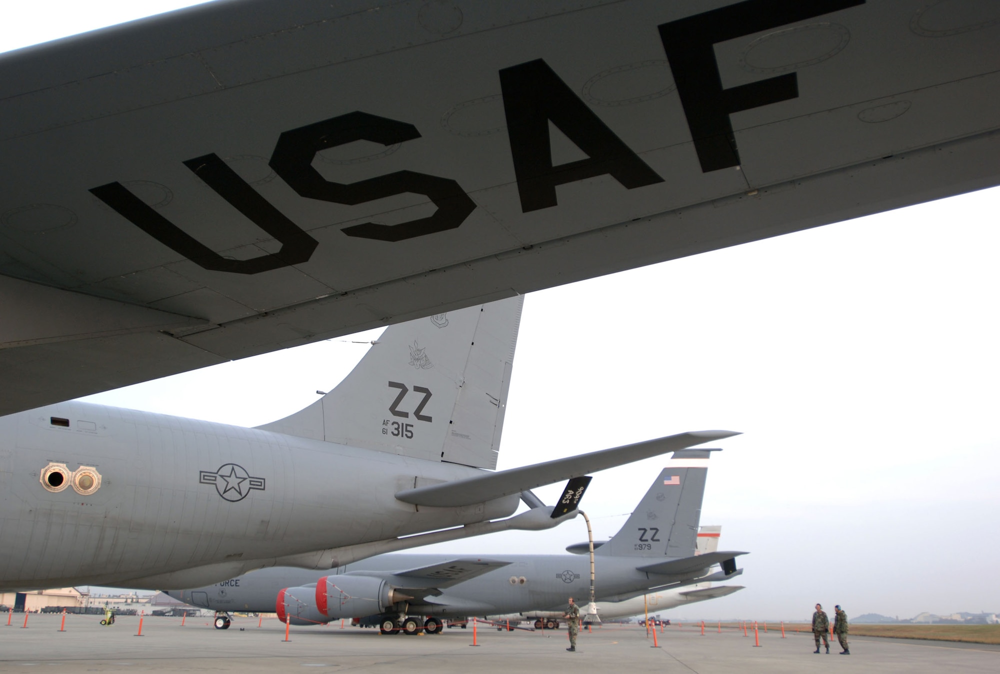 YOKOTA AIR BASE, Japan (AFPN) -- (Left to right) Tech Sgt. Julian Christian,  Staff Sgt. Gene Pietro and Senior Airman James Taimanglo inspect their KC-135 Stratotanker aircraft before an exercise Cope North 05 morning sortie. Cope North is a bilateral exercise designed to enhance U.S. and Japanese air operations. It gives pilots from both countries opportunities to conduct training in air combat tactics, electronic combat and airborne air control. The Airmen are with the 718th Aircraft Maintenance Squadron here.  (U.S. Air Force photo by Master Sgt. Val Gempis)