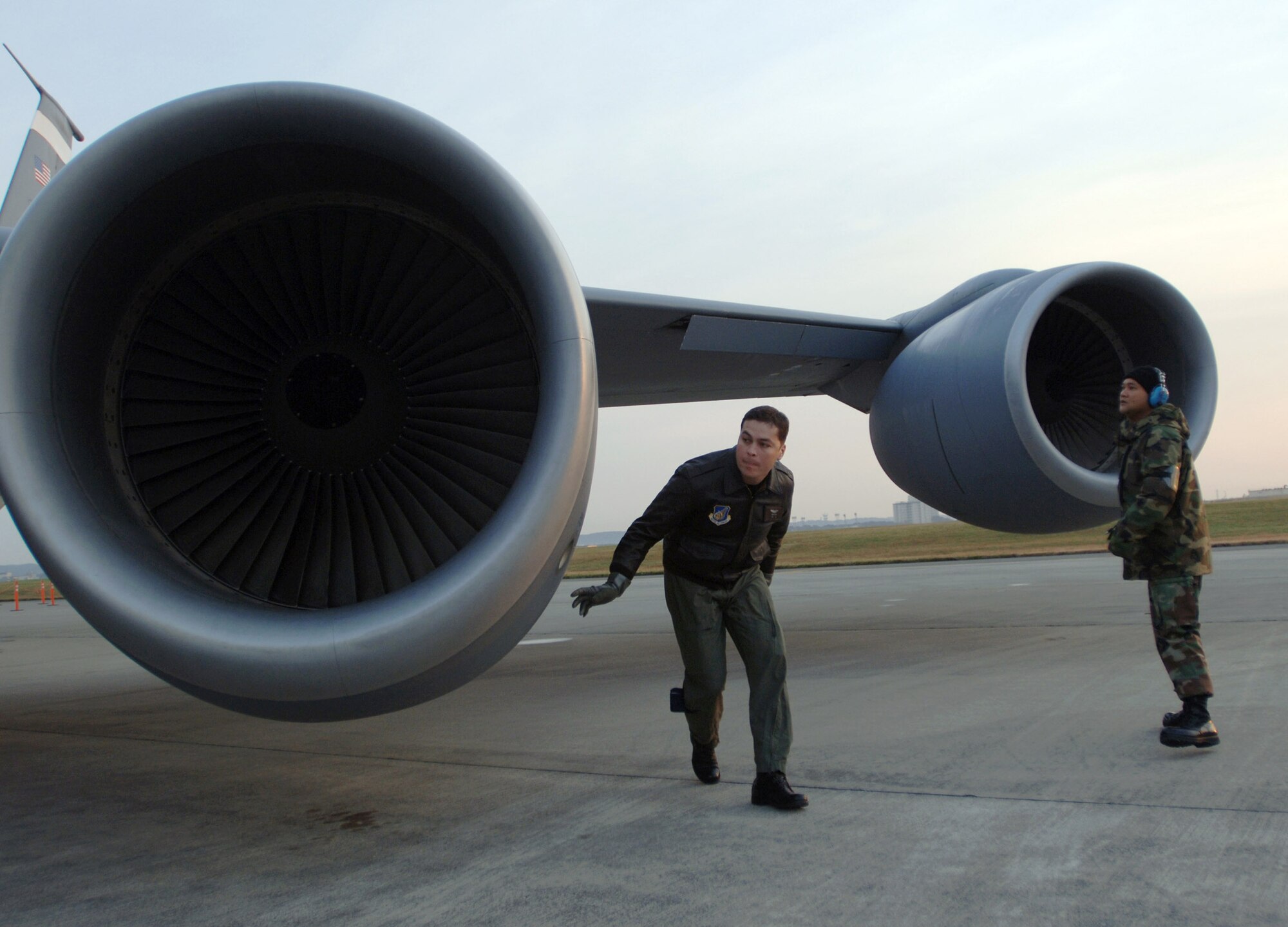 YOKOTA AIR BASE, Japan (AFPN) -- KC-135 Stratotanker pilot Capt. Brian Burr (left), preflights his aircraft with crew chief Senior Airman James Taimanglo before an exercise Cope North 05 morning sortie. Cope North is a bilateral exercise to enhance U.S. and Japanese air operations. It gives pilots from both countries opportunities to conduct training in air combat tactics, electronic combat and airborne air control. Captain Burr is with the 909th Air Refueling Squadron, and Airman Taimanglo with the 718th Aircraft Maintenance Squadron here.  (U.S. Air Force photo by Master Sgt. Val Gempis)