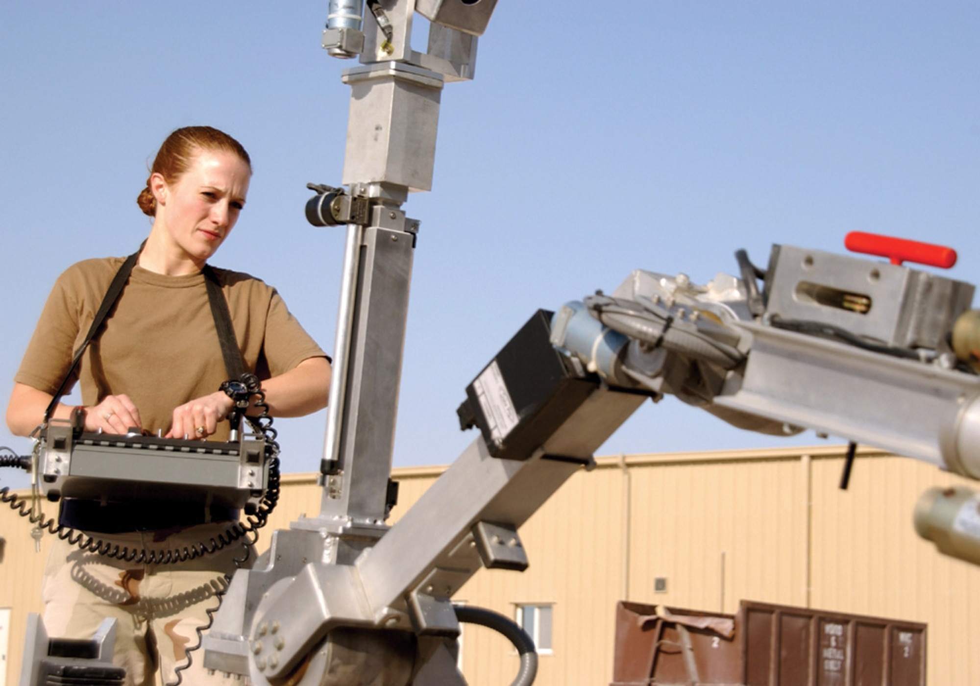 SOUTHWEST ASIA (AFPN) -- Staff Sgt. Lindsey Leitz demonstrates how to use the explosive ordnance disposal Andros MK V robot. The remote-controlled bomb disposal unit uses devices to remotely open vehicles and pull items out of vehicles. Sergeant Leitz is with the 379th Expeditionary Civil Engineering Squadron explosive ordnance disposal unit at this base. (U.S. Air Force photo by Tech. Sgt. Sarah Webb)           