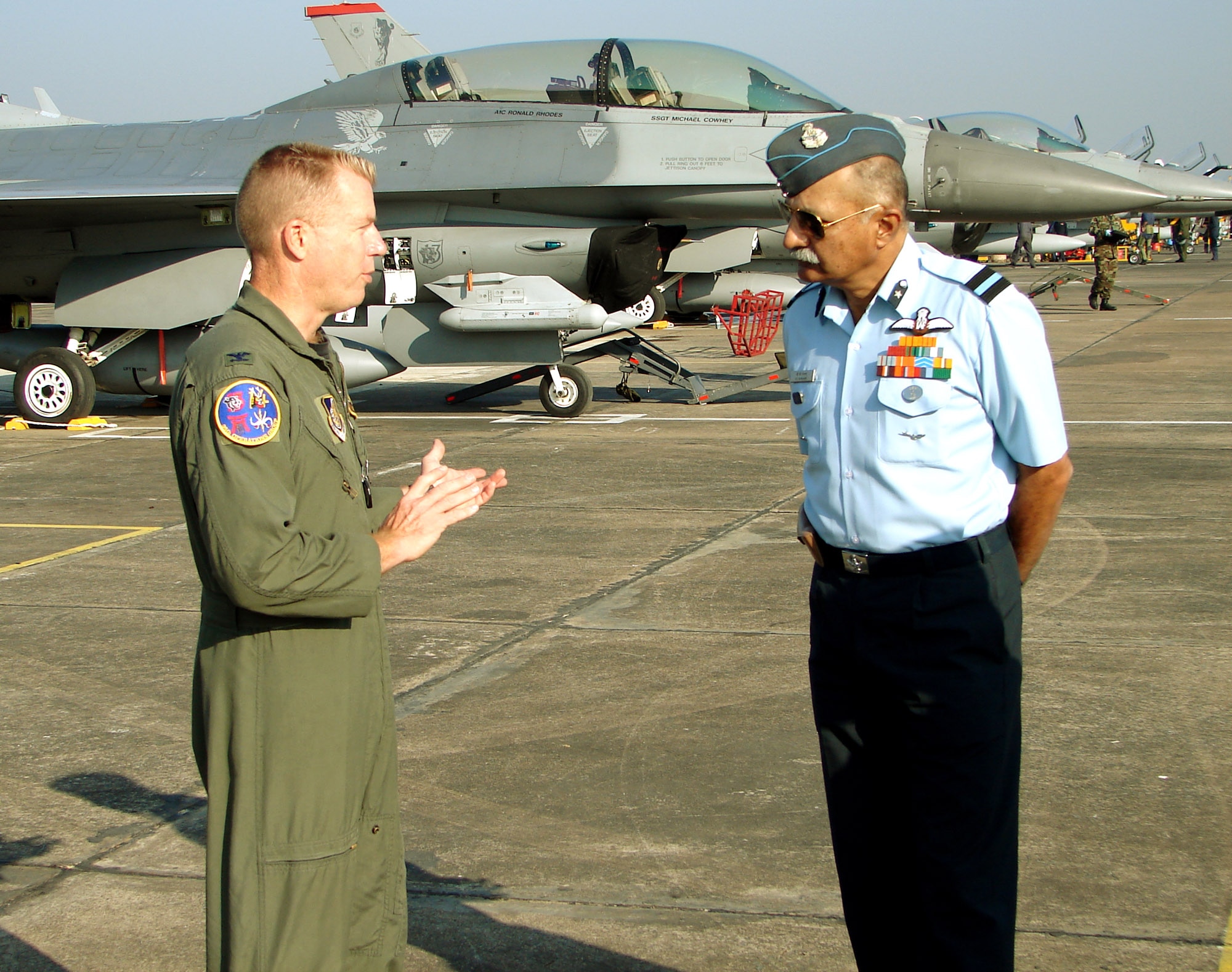 KALAIKUNDA AIR STATION, India (AFPN) -- Col. Rusty Cabot talks with Indian air force Gen. B.C. Nanjapa about the capabilities of the F-16 Fighting Falcon. A dozen of the fighters are here from Misawa Air Base, Japan, are here with about 250 U.S. Airmen from five Pacific bases participating in exercise Cope India 06. The exercise aims to strengthen ties and promote interoperability between the two countries' air forces. Colonel Cabot is the deployed forces commander here. (U.S. Air Force photo by Capt. John Redfield).