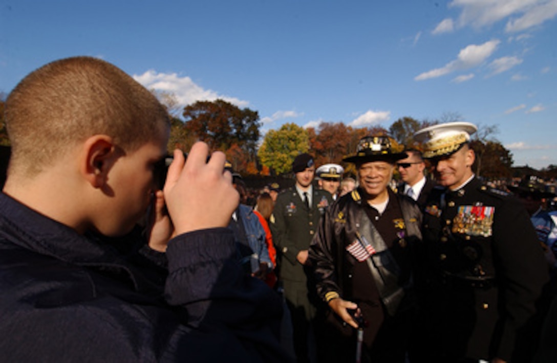 Chairman of the Joint Chiefs of Staff Gen. Peter Pace, U.S. Marine Corps, poses for a photograph with a fellow Vietnam vet at the Vietnam Veterans Memorial Wall in Washington, D.C., on Nov. 11, 2005. Pace was the keynote speaker at the annual Veterans Day ceremony at the Wall. 
