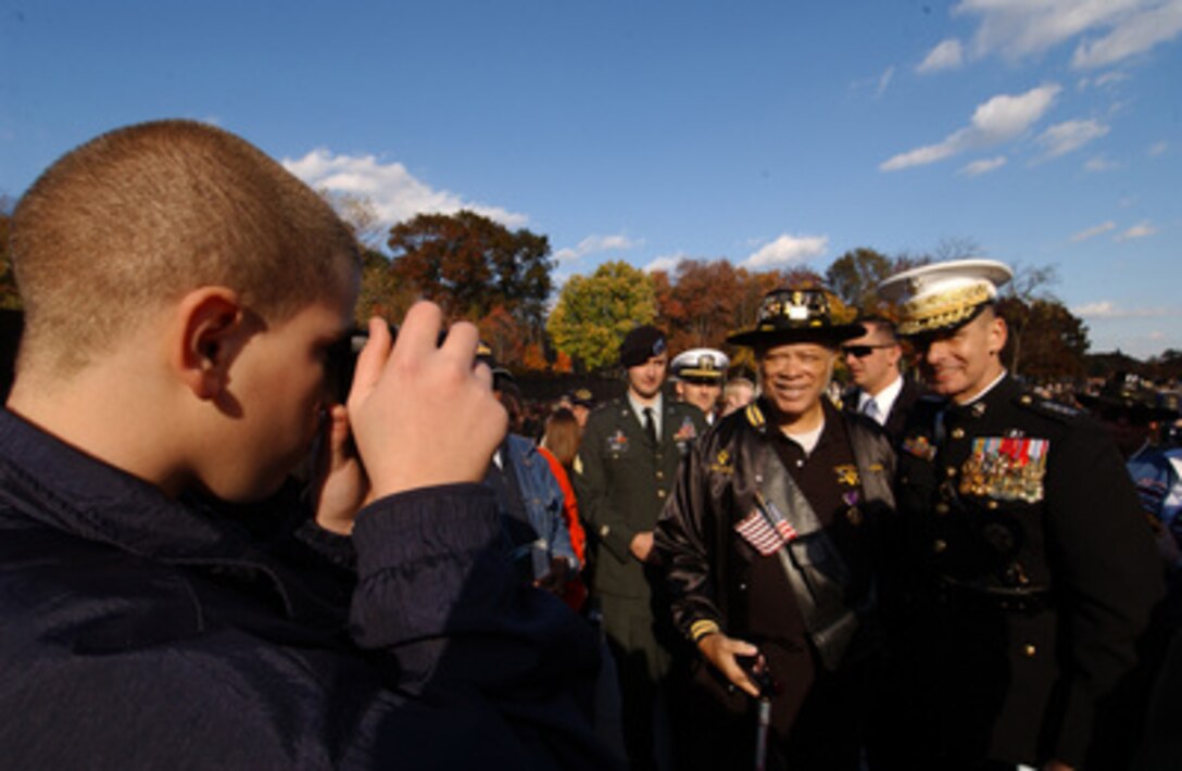 Chairman of the Joint Chiefs of Staff Gen. Peter Pace, U.S. Marine Corps, poses for a photograph with a fellow Vietnam vet at the Vietnam Veterans Memorial Wall in Washington, D.C., on Nov. 11, 2005. Pace was the keynote speaker at the annual Veterans Day ceremony at the Wall. 