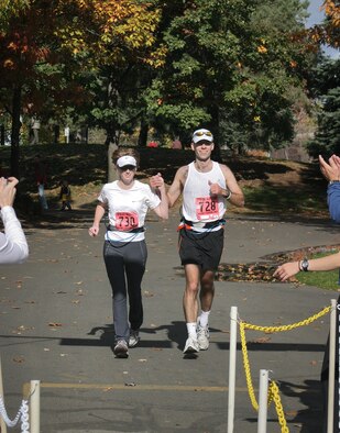 SPOKANE, Wash. -- Maj. Michael Moyles and his wife, Angela, run hand in hand toward the finish line at the Spokane Marathon. Major Moyles, who was diagnosed with brain cancer in 1999, had defied the odds to beat the cancer. He is a commercial satellite communications operational manager with U.S. Strategic Command at Offutt Air Force Base, Neb. (U.S. Air Force photo) 