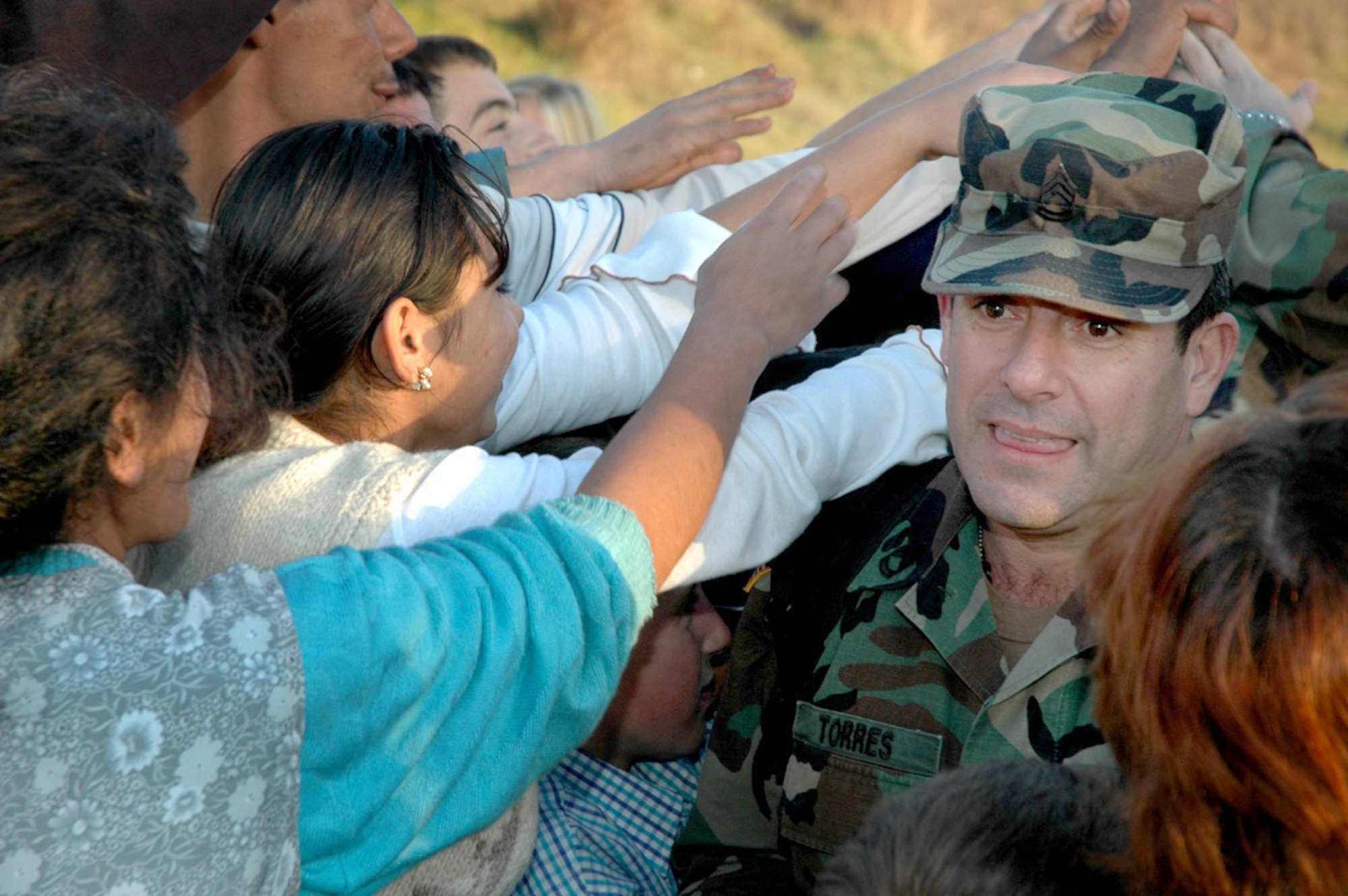 NOVO BRDO, Kosovo (AFPN) -- Children of the Novo Brdo region of Kosovo reach for pieces of candy being distributed by the U.S. Headquarters Kosovo Force personnel during a humanitarian mission. (Ukranian Army photo by 1st Lt. Maksym Nedria)