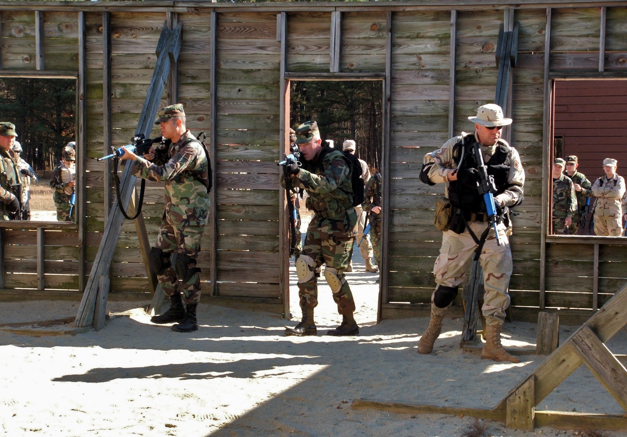 FORT DIX, N.J. (AFPN) -- Airmen participating in the Combat Interrogator Course 06-1 practice a close quarter combat maneuver at a tactical area. The class was taught by the 421st Combat Training Squadron at the Air Mobility Warfare Center, Fort Dix, Nov. 14. (U.S. Air Force Photo by Tech. Sgt. Scott T. Sturkol)