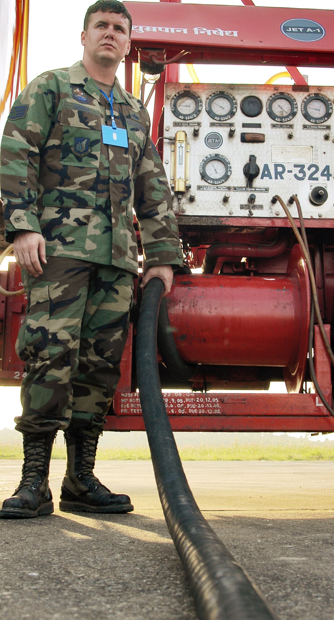 KALAIKUNDA AIR STATION, India (AFPN) -- Staff Sgt. Trey Norris monitors the fueling of an F-16 Fighting Falcon during Cope India 2006. During the exercise, Sergeant Norris has worked closely with the Indian Oil Company to completing 146 aircraft refuels -- nearly 235,000 gallons of fuel. Sergeant Norris is a fuels distribution supervisor from the 374th Logistics Readiness Squadron at Yokota Air Base, Japan. (U.S. Air Force photo by Tech. Sgt. Martin Jackson)