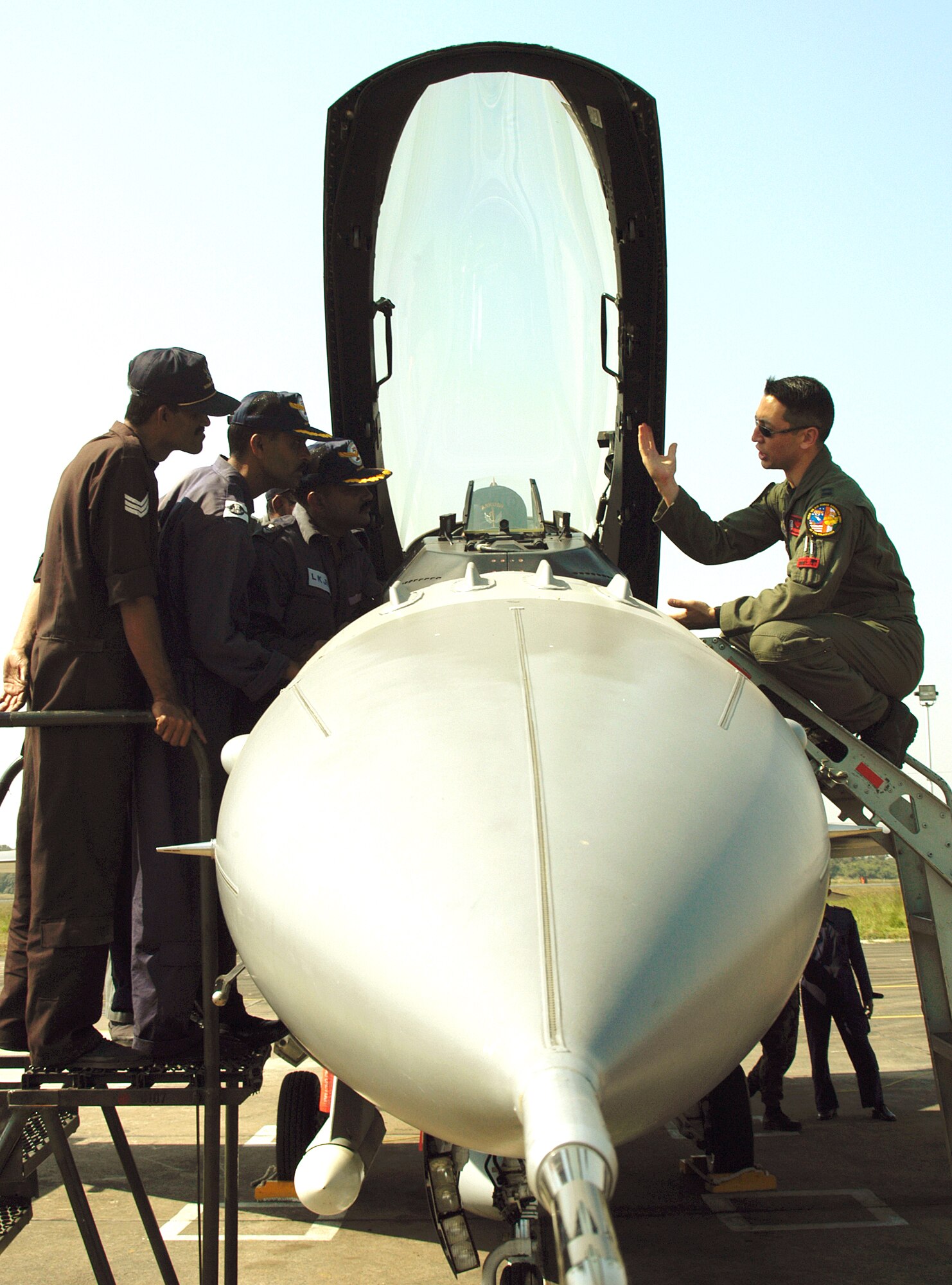 KALAIKUNDA AIR STATION, India (AFPN) -- Capt. Kevin Jones gives a cockpit tour to Indian Air Force airmen during Cope India 2006. Currently, the U.S aircraft have flown 113 sorties with the Indian air force. Captain Jones is an F-16 Fighting Falcon pilot from the 13th Fighter Squadron, Misawa Air Base, Japan. (U.S. Air Force photo by Tech Sgt. Martin Jackson)